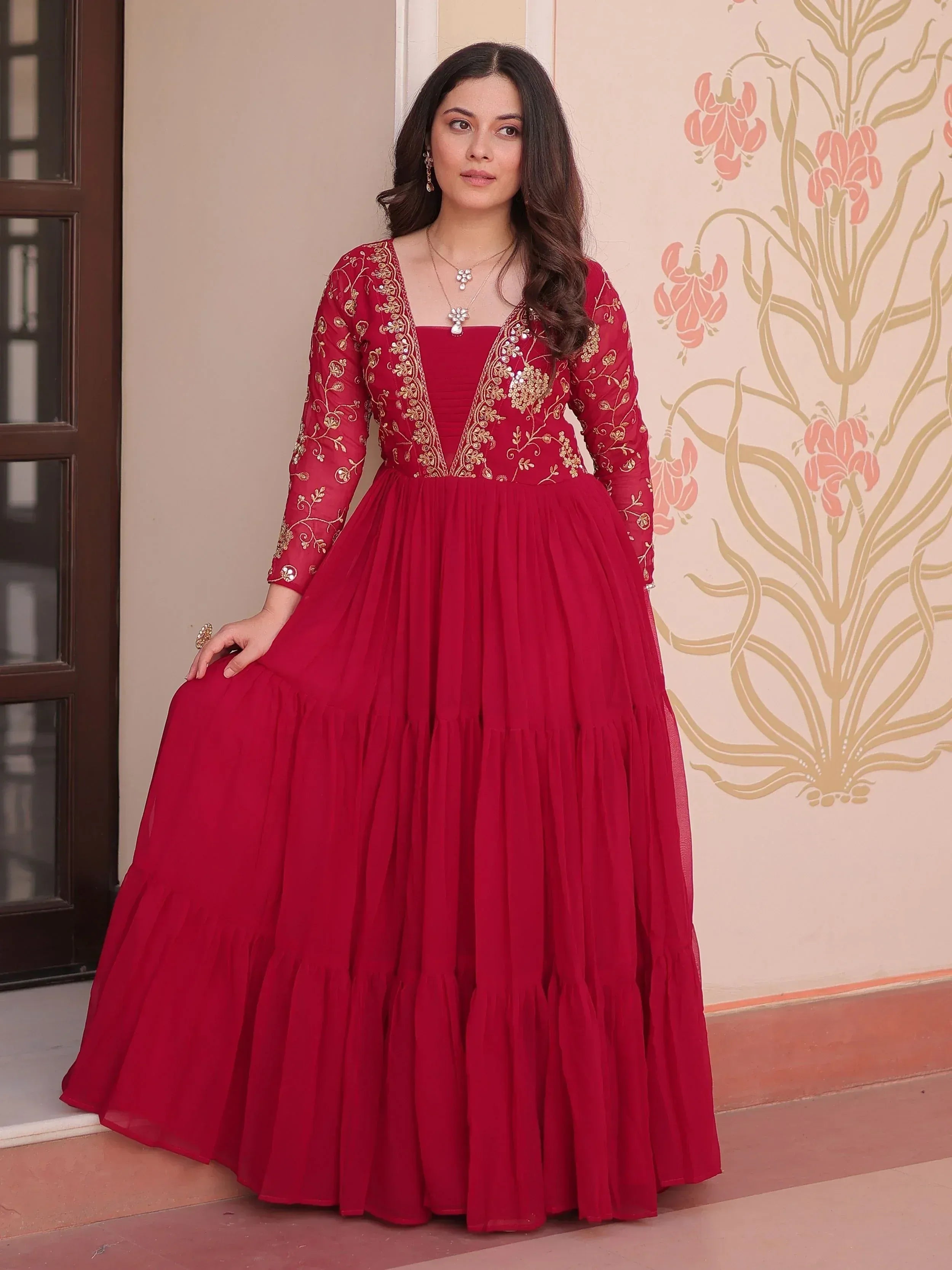 Red ethnic gown with gold embroidery, perfect for Indian celebrations and festive occasions.