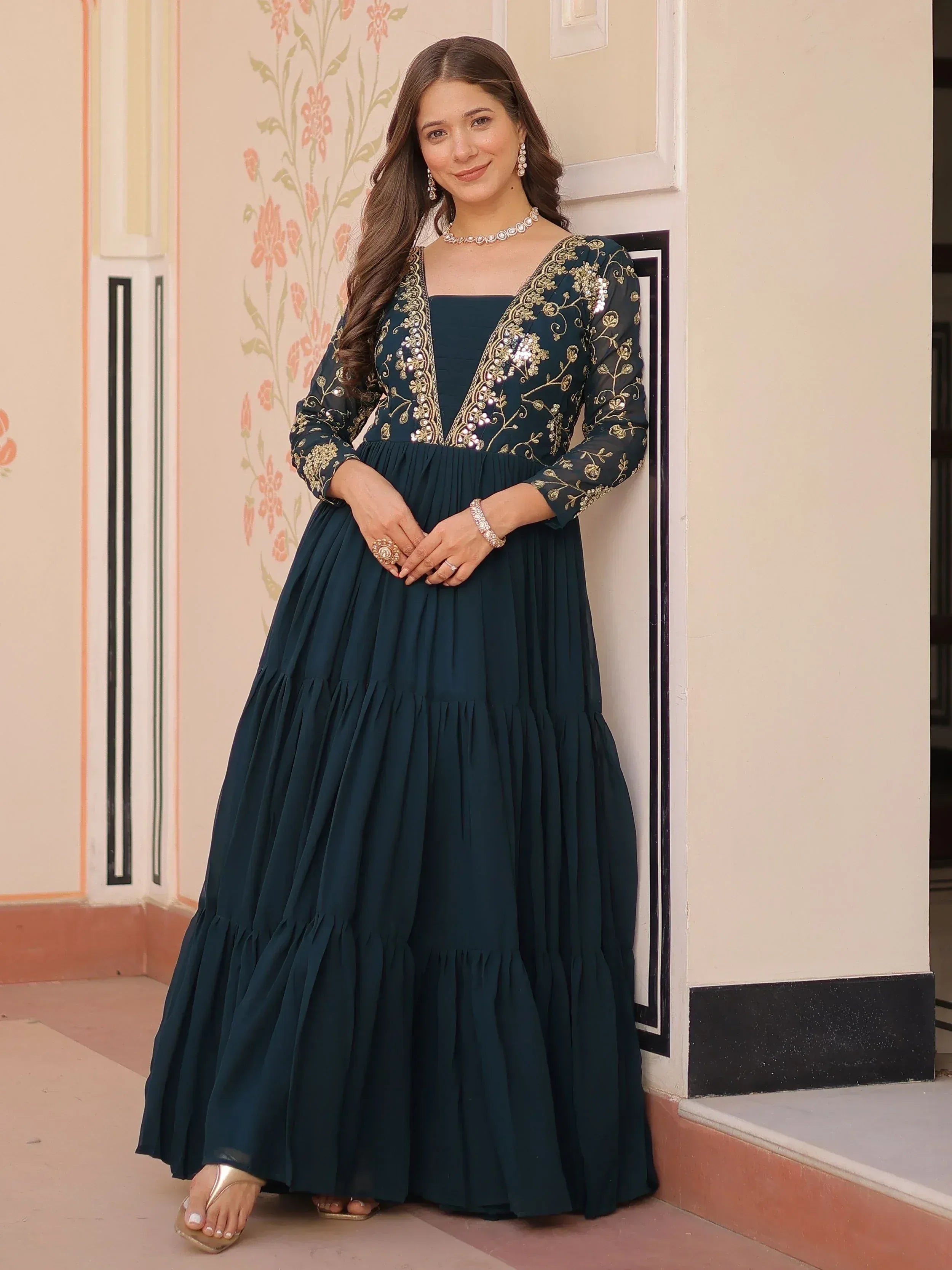 Elegant teal ethnic gown with gold embroidery and pleated skirt, perfect for Indian occasions