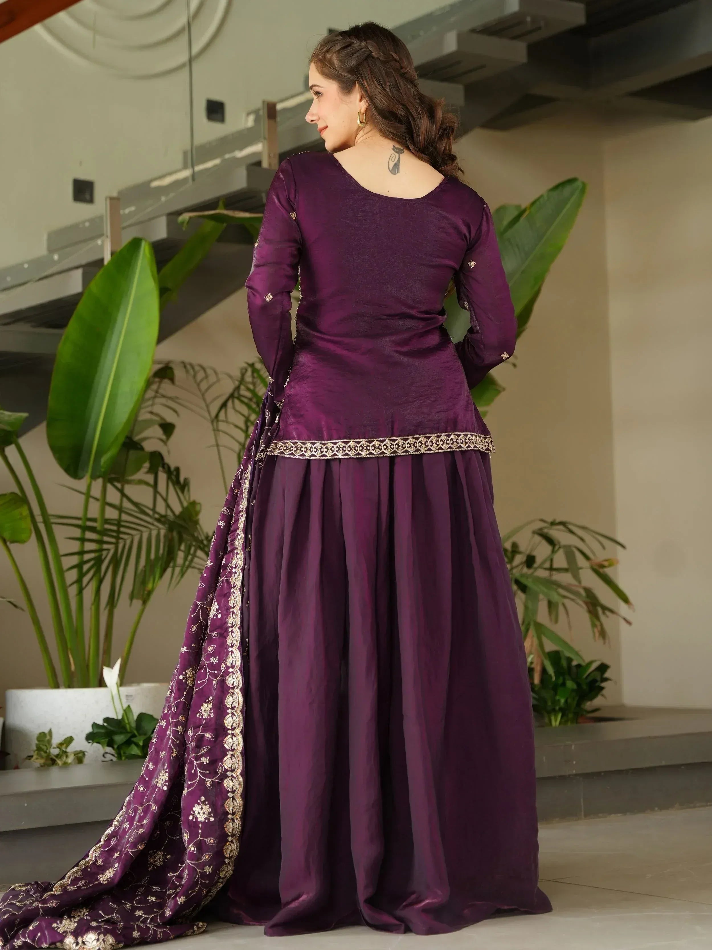 Purple ethnic gown with gold embroidery, perfect for Indian celebrations and events.