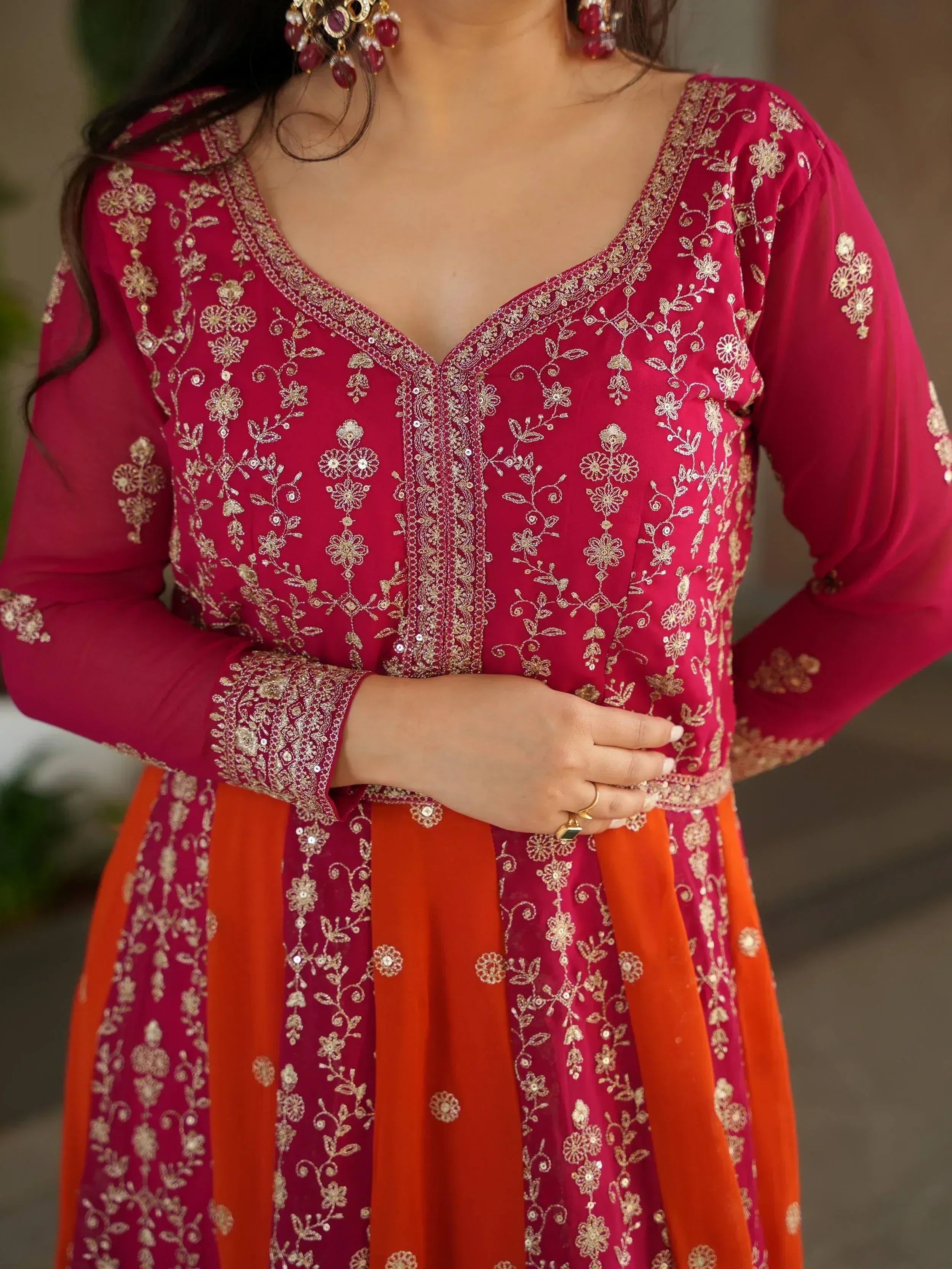 Pink and orange embroidered Indian ethnic gown with gold floral detailing and matching jewelry