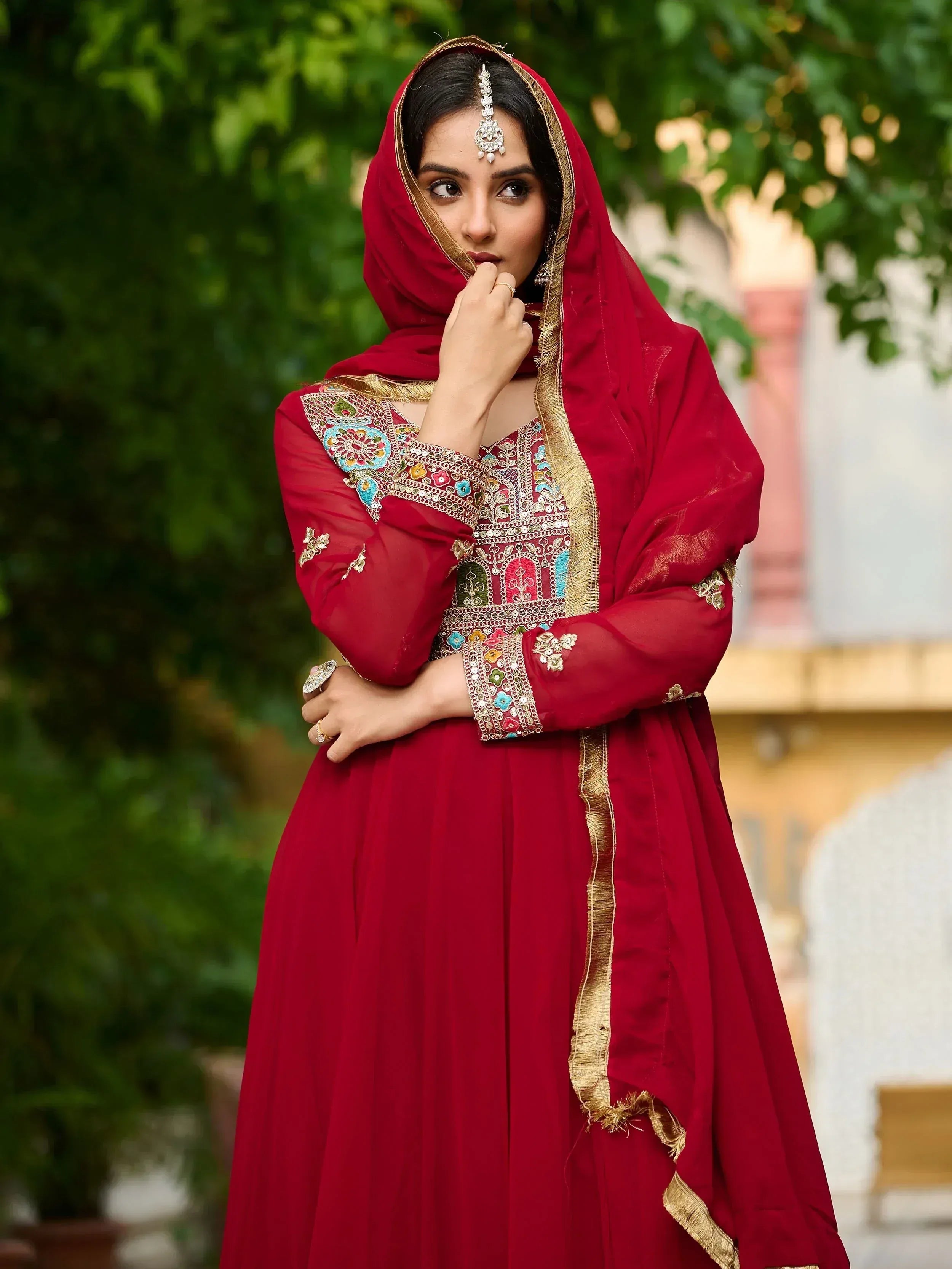 Red embroidered Indian ethnic anarkali with gold trim and dupatta, perfect for weddings or festivals