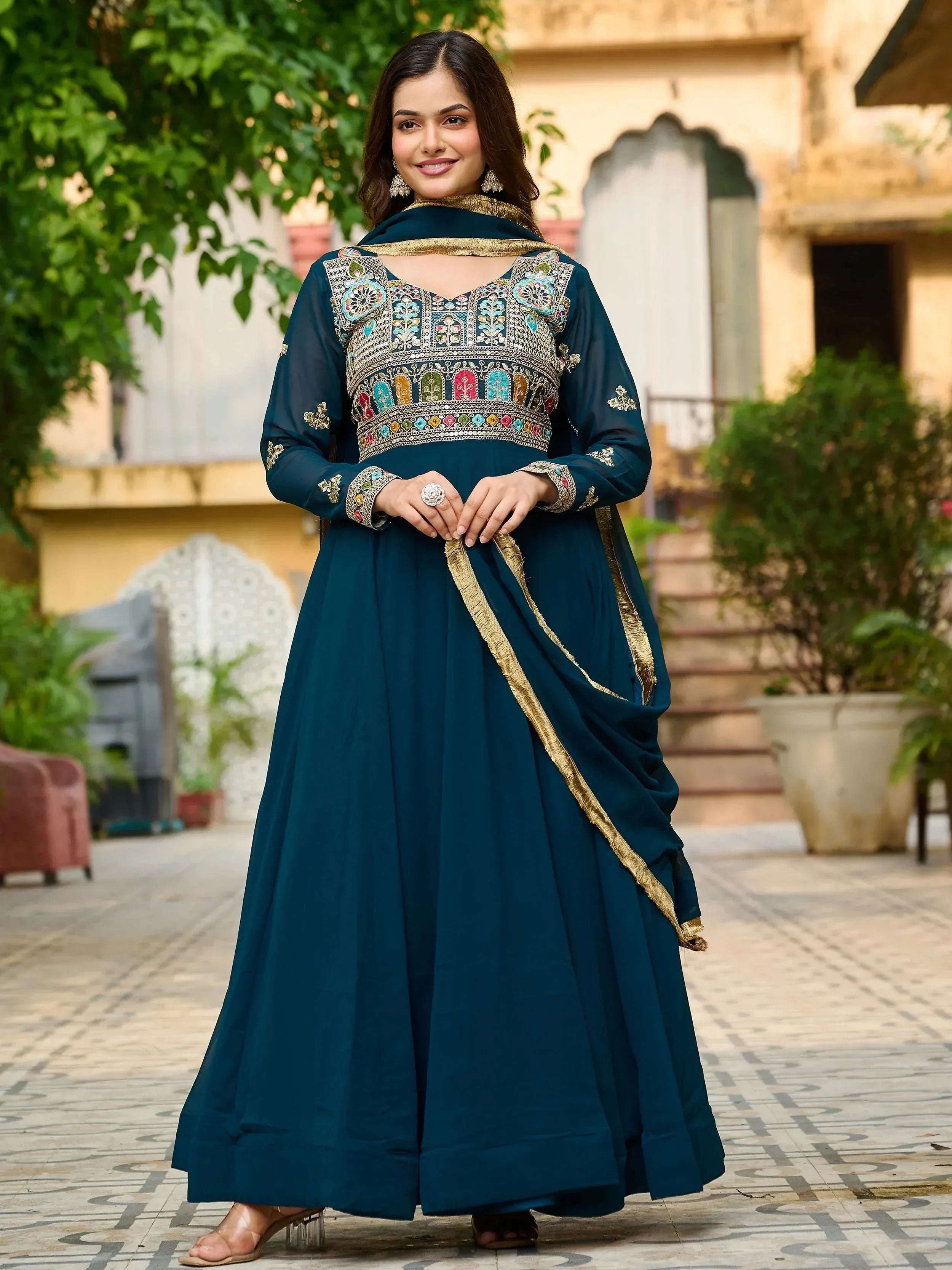 Elegant teal anarkali with colorful embroidery and gold trim, perfect for Indian ethnic wear