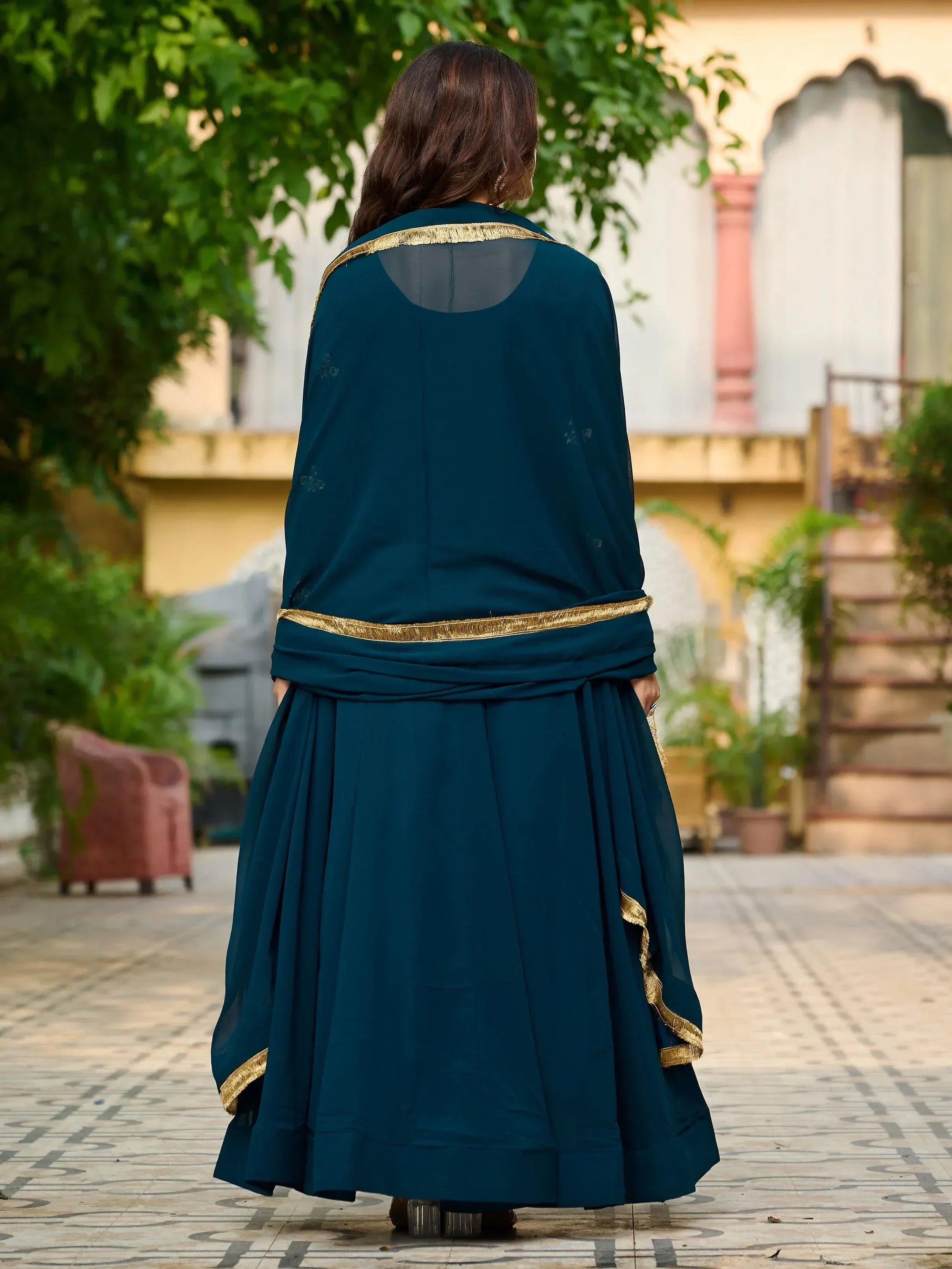 Teal ethnic gown with gold trim, back view, perfect for Indian festive occasions