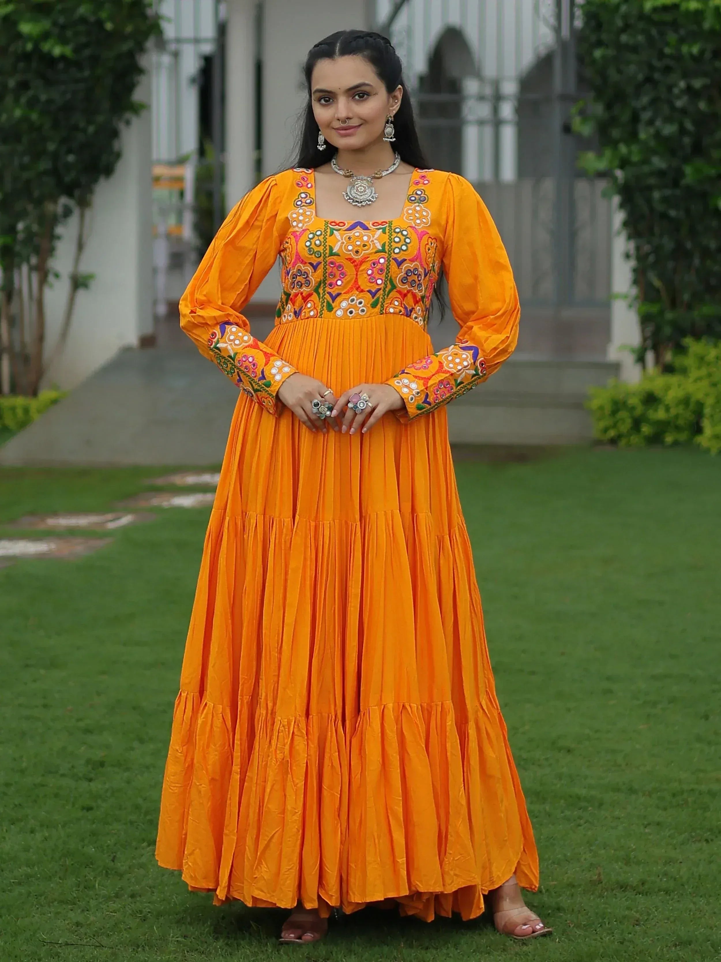 Vibrant orange ethnic gown with floral embroidery, perfect for Indian festive wear and occasions.