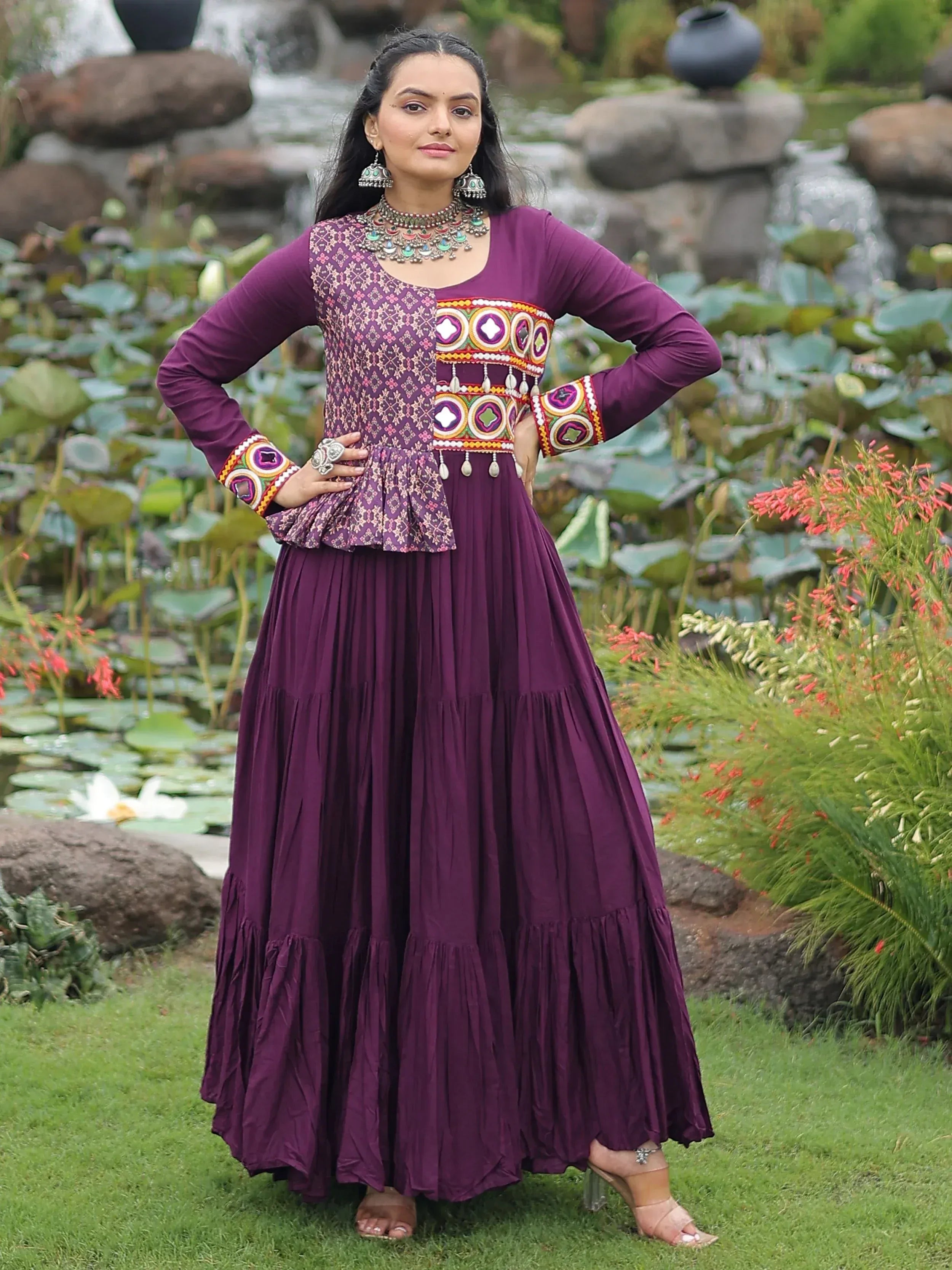 Purple ethnic gown with embroidered peplum top and pleated skirt, perfect for Indian occasions
