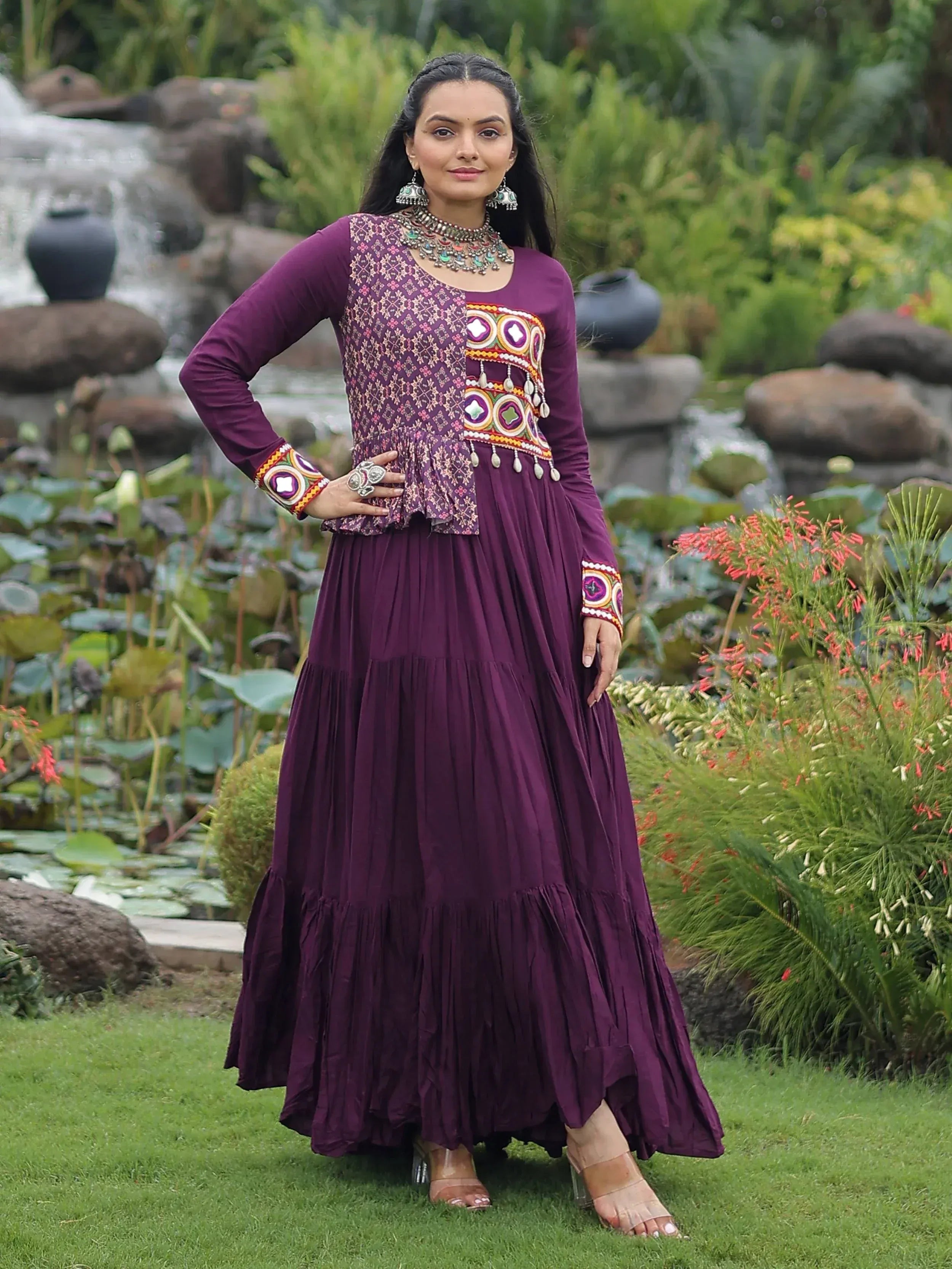 Purple ethnic gown with mirror work and embroidery, perfect for Indian occasions and festive wear.