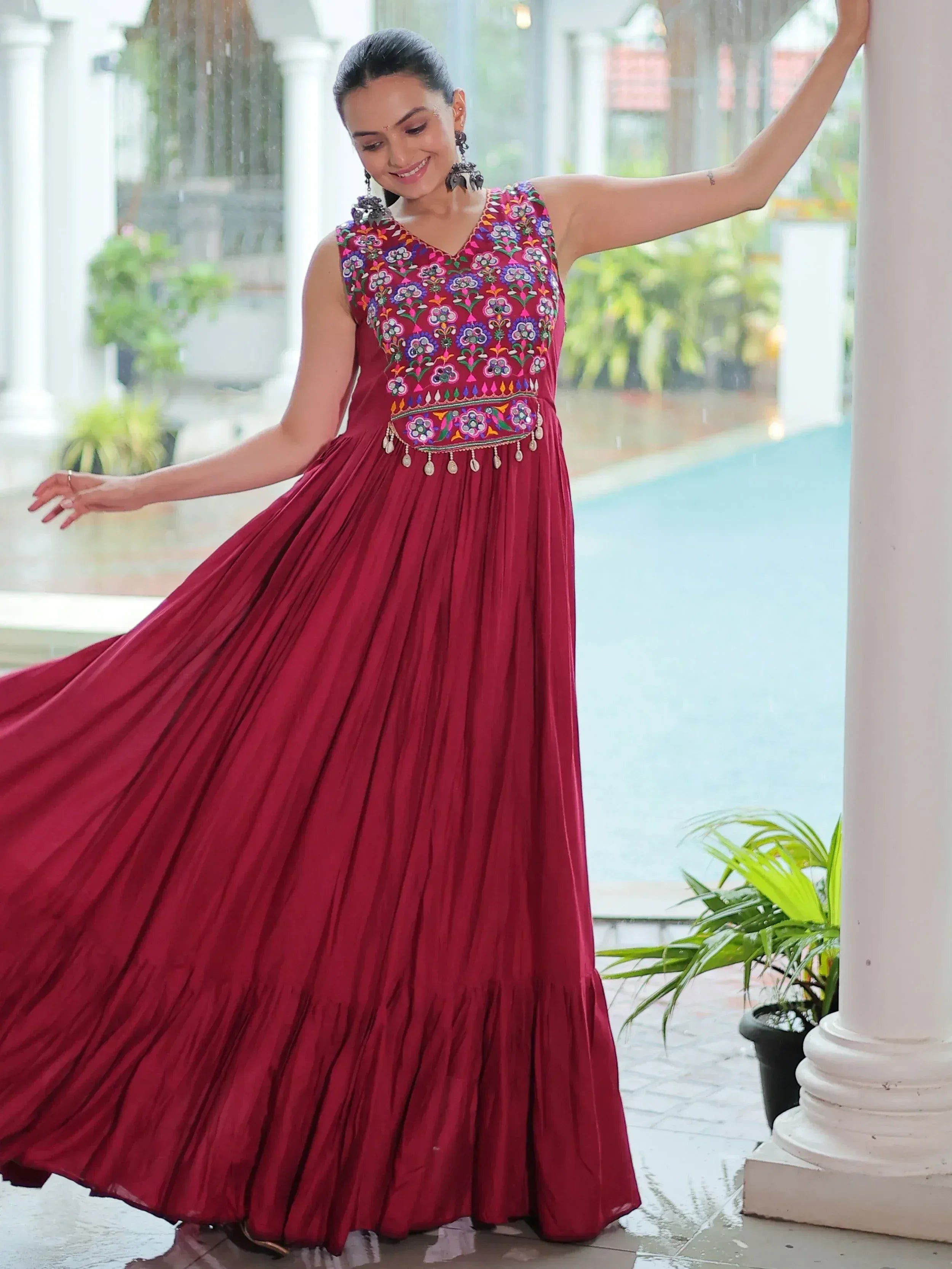 Woman in maroon ethnic gown with floral embroidery, perfect for Indian festive occasions