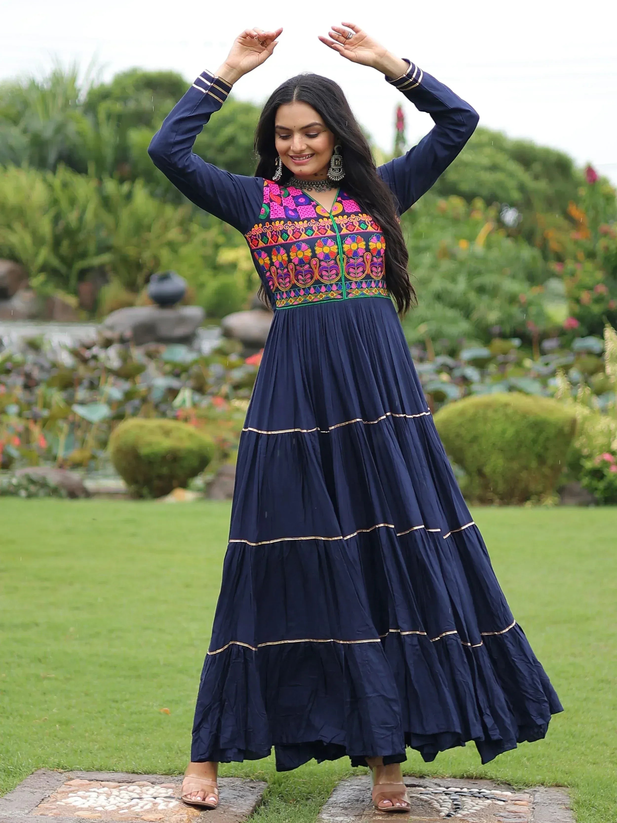 Navy blue ethnic gown with colorful floral embroidery, tiered skirt, perfect for festive occasions