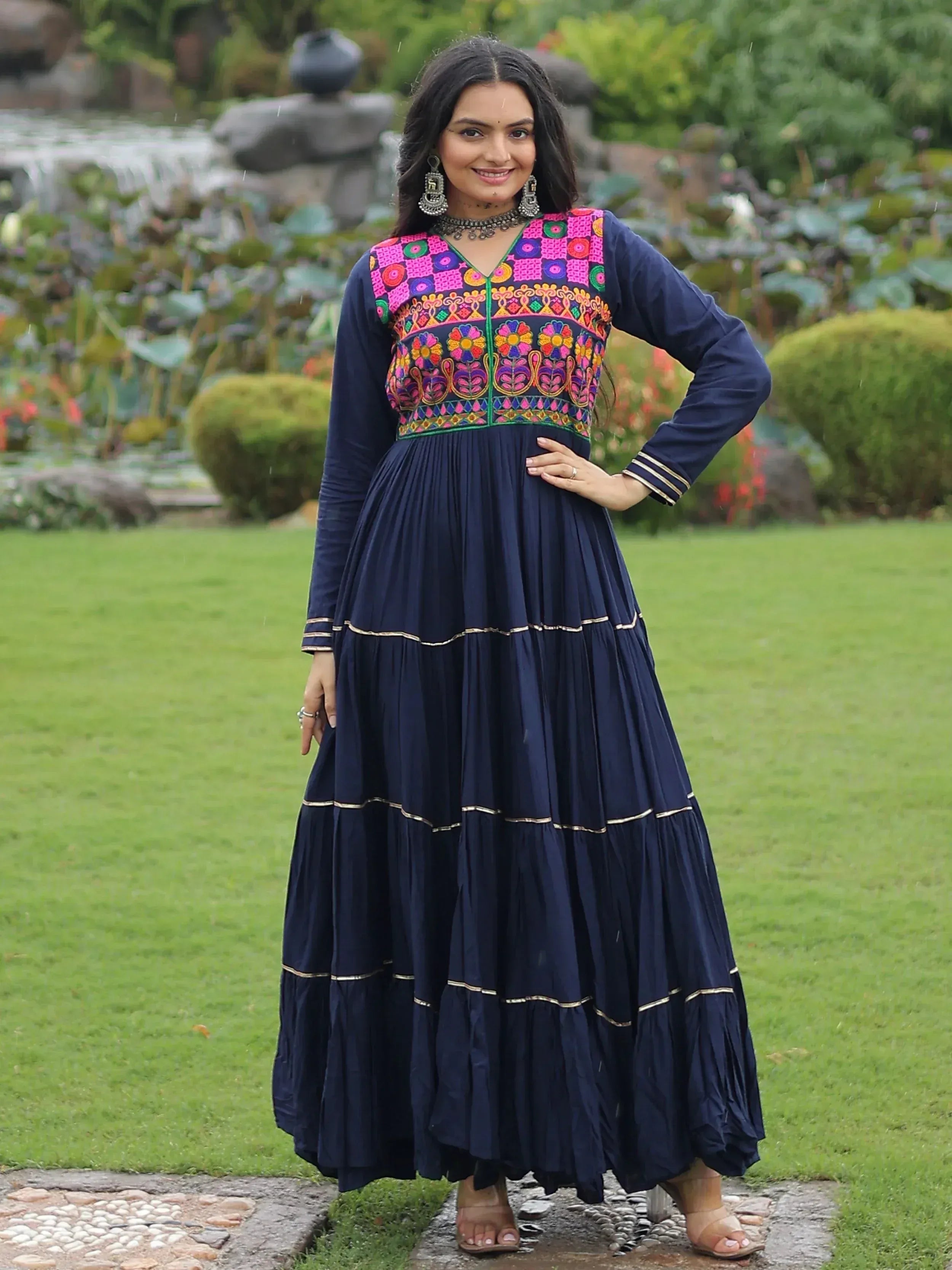 Navy blue ethnic gown with vibrant floral embroidery, perfect for Indian occasions and festive wear.