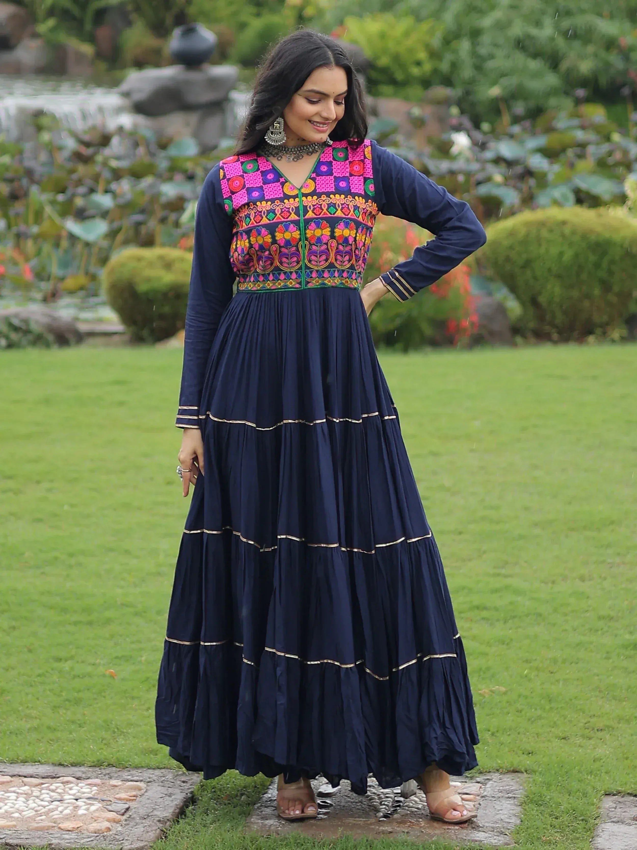 Navy blue ethnic gown with colorful floral embroidery, perfect for Indian festive occasions