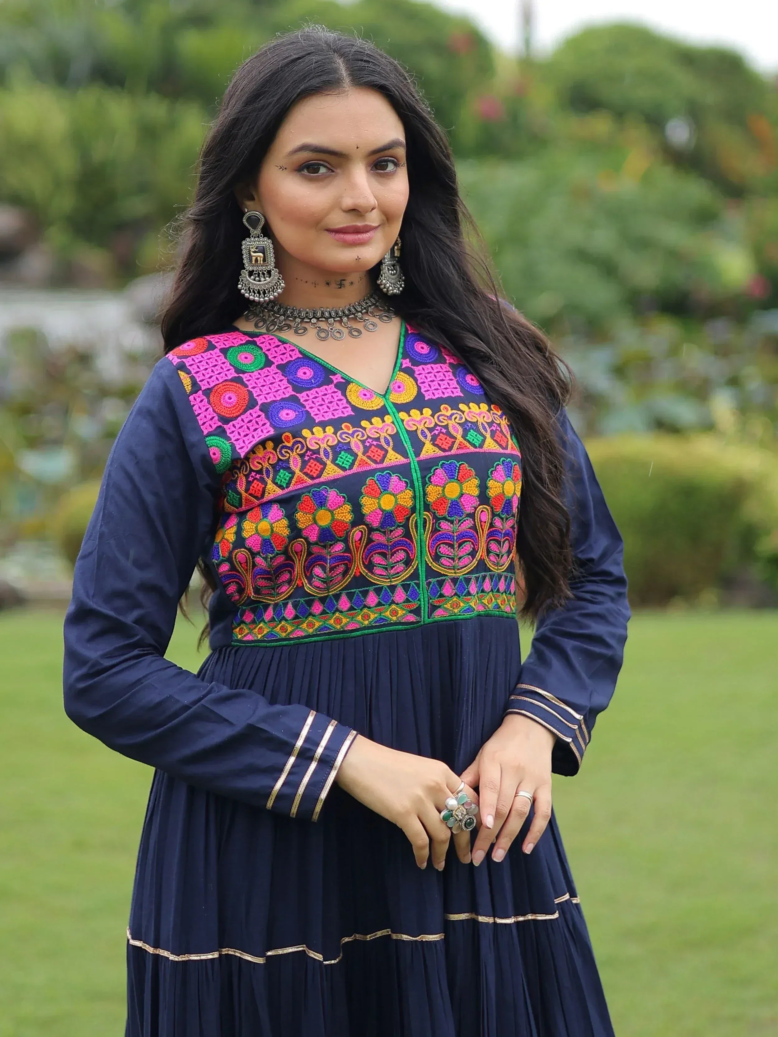 Navy blue ethnic gown with vibrant floral embroidery, perfect for Indian occasions and festive wear.