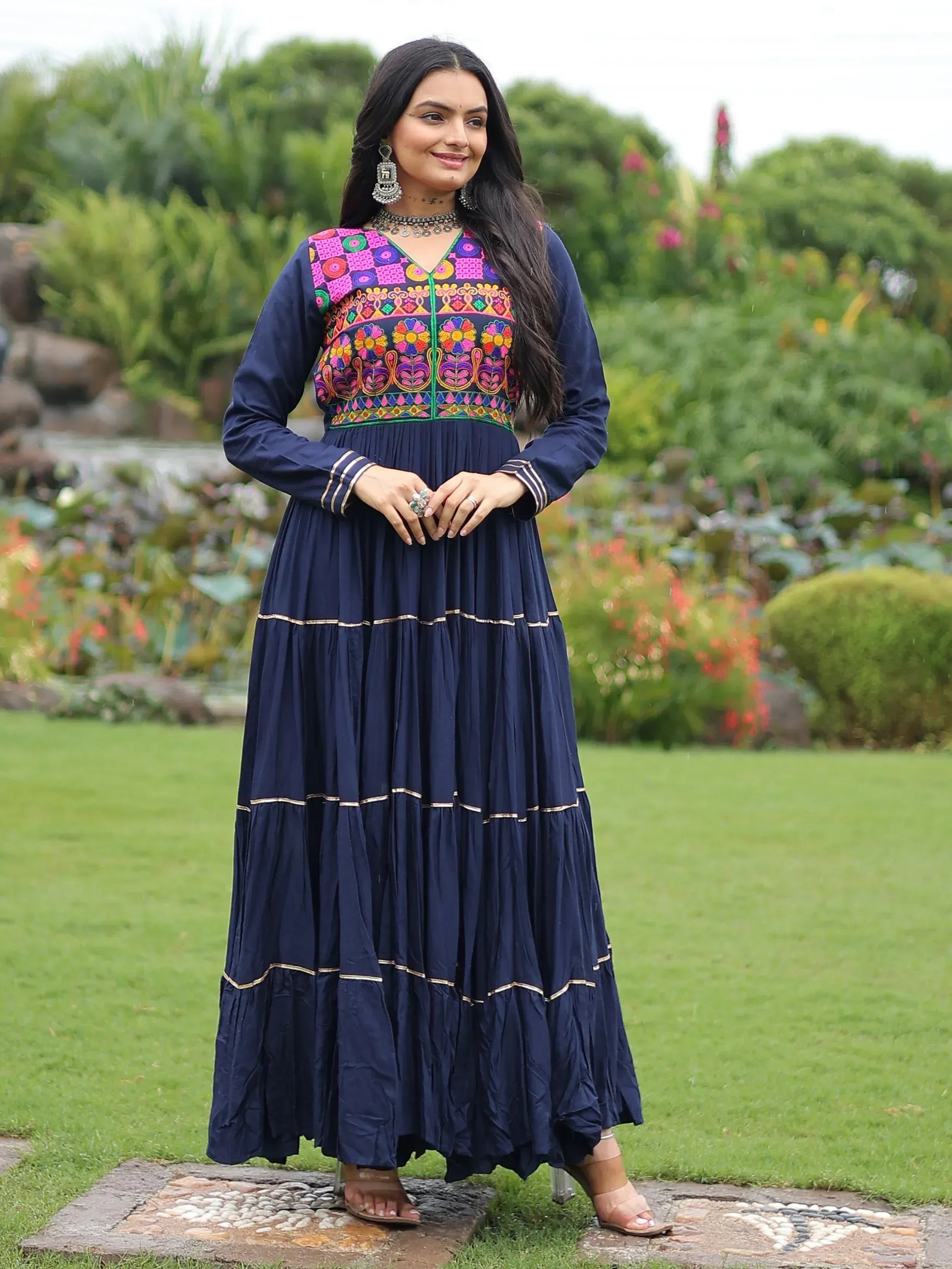 Navy blue ethnic gown with vibrant floral embroidery, perfect for Indian festive occasions and weddings.
