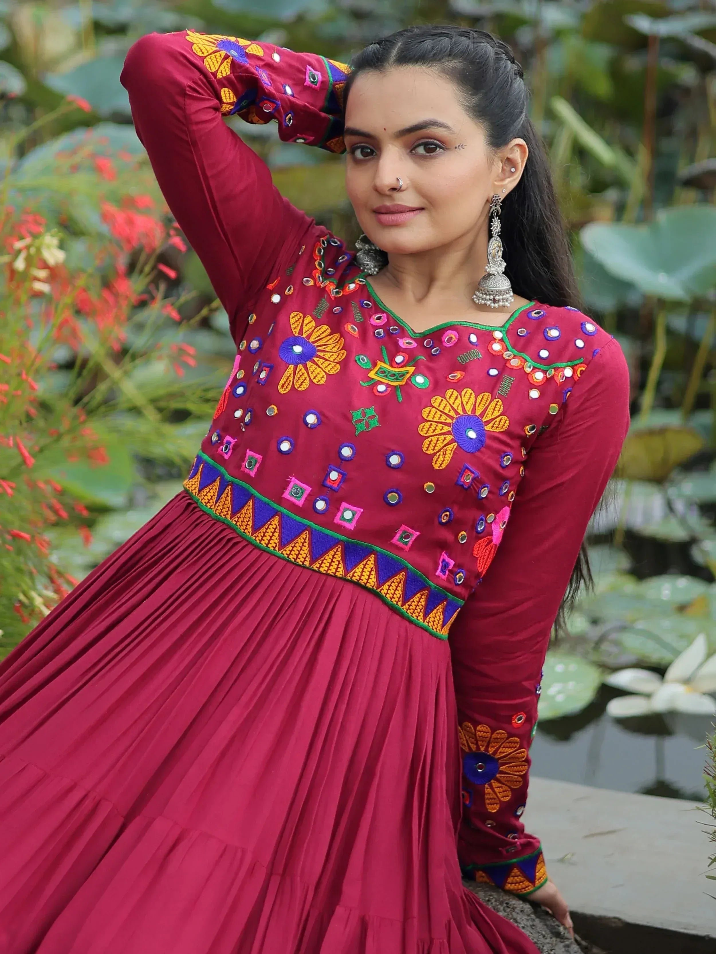 Maroon ethnic gown with mirror work and floral embroidery, perfect for Indian occasions