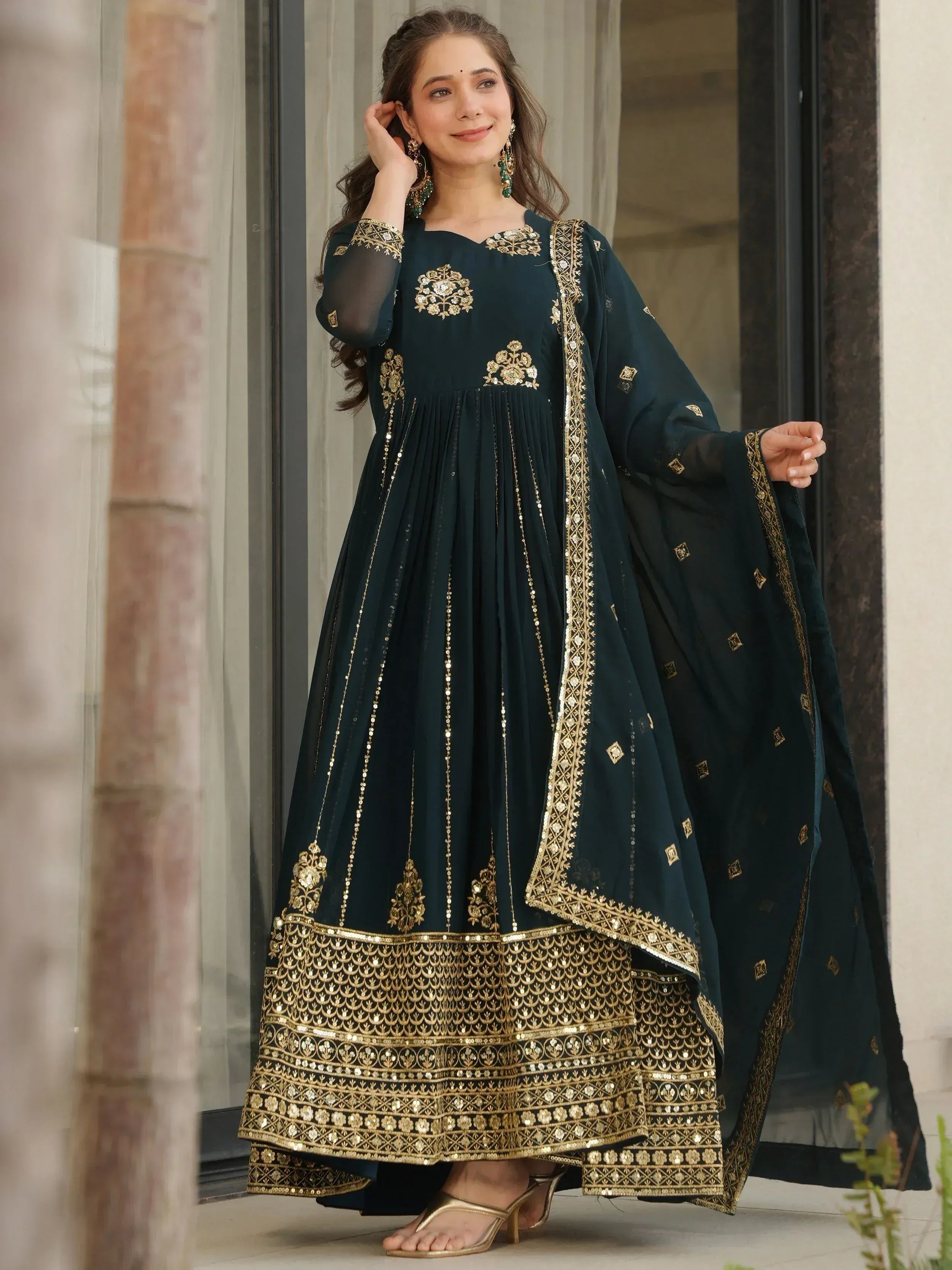 Elegant dark green Anarkali with gold embroidery and sequin detailing, perfect for Indian ethnic occasions.