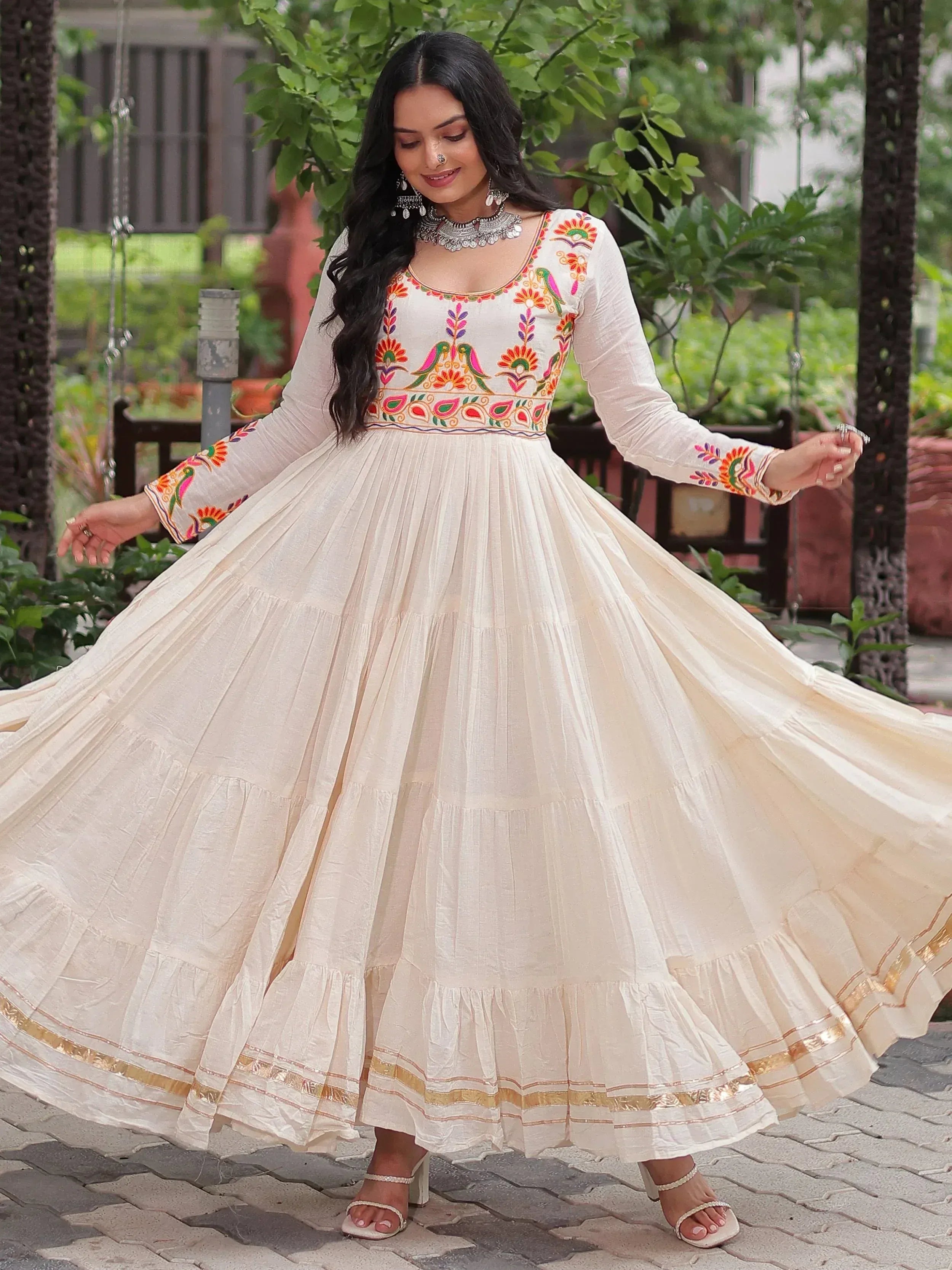 Cream embroidered anarkali gown with floral and bird motifs, perfect for Indian ethnic wear occasions