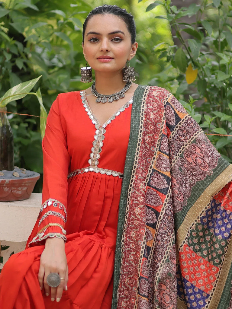 Vibrant red ethnic gown with mirror work and printed dupatta, perfect for Indian festive wear
