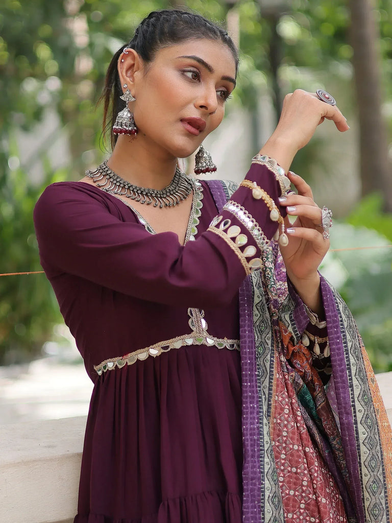 Elegant maroon ethnic gown with mirror work and traditional jewelry for Indian festive wear