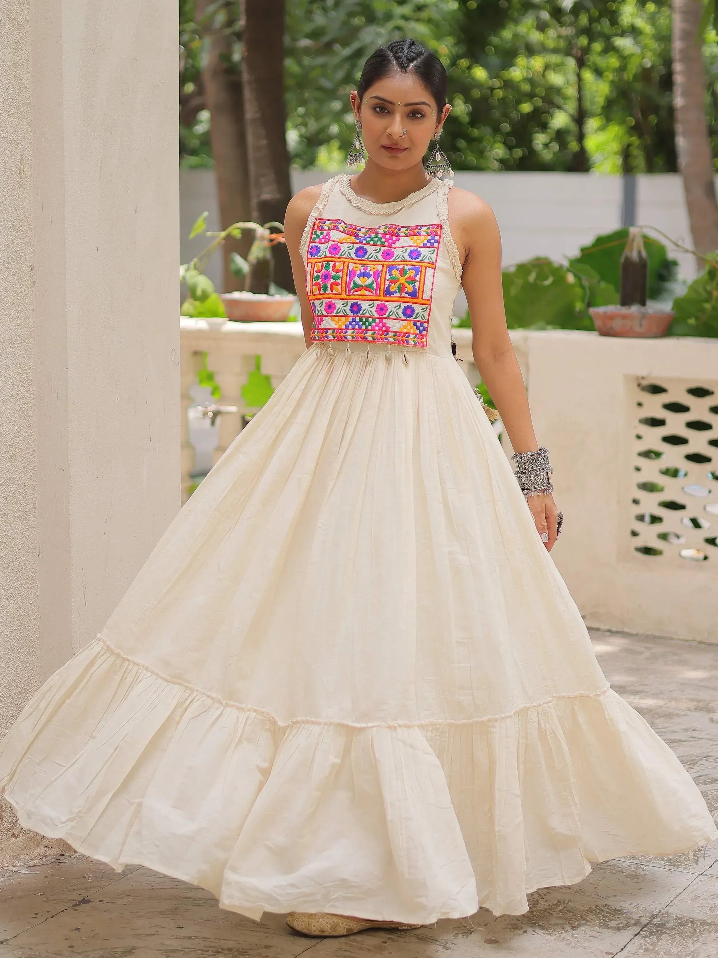 Cream ethnic gown with colorful floral embroidery, perfect for Indian occasions and festive wear.