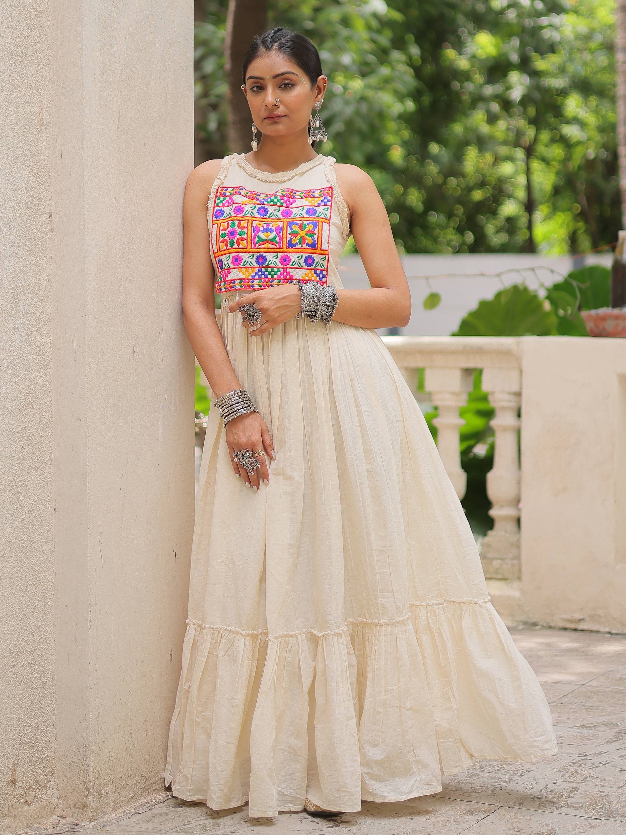 Cream ethnic gown with colorful floral embroidery, perfect for Indian occasions and festive wear.
