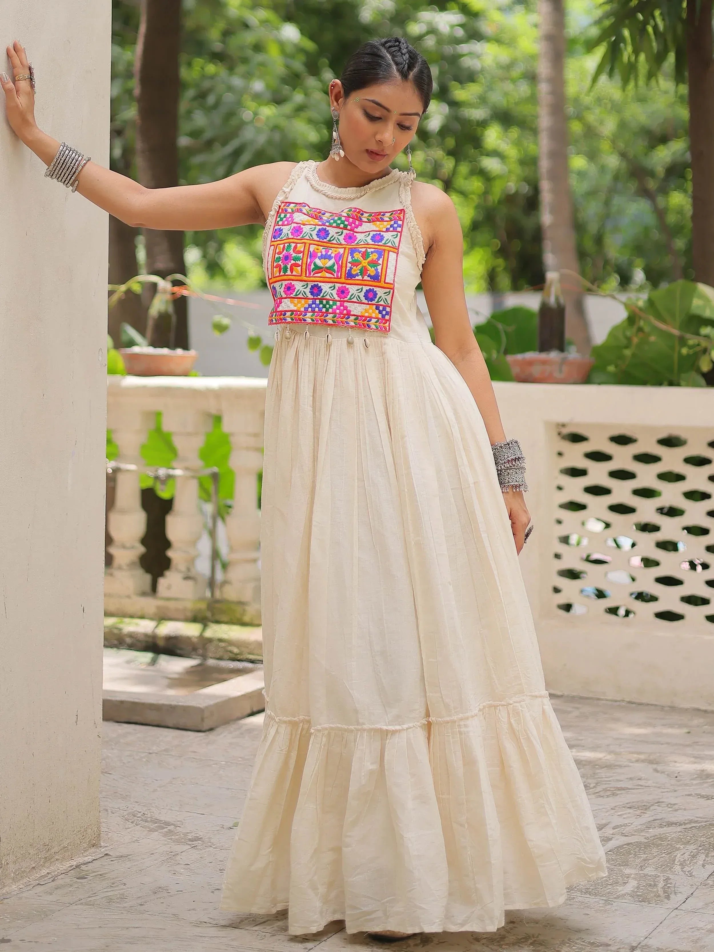 Cream ethnic gown with colorful floral embroidery, perfect for Indian festive wear and occasions