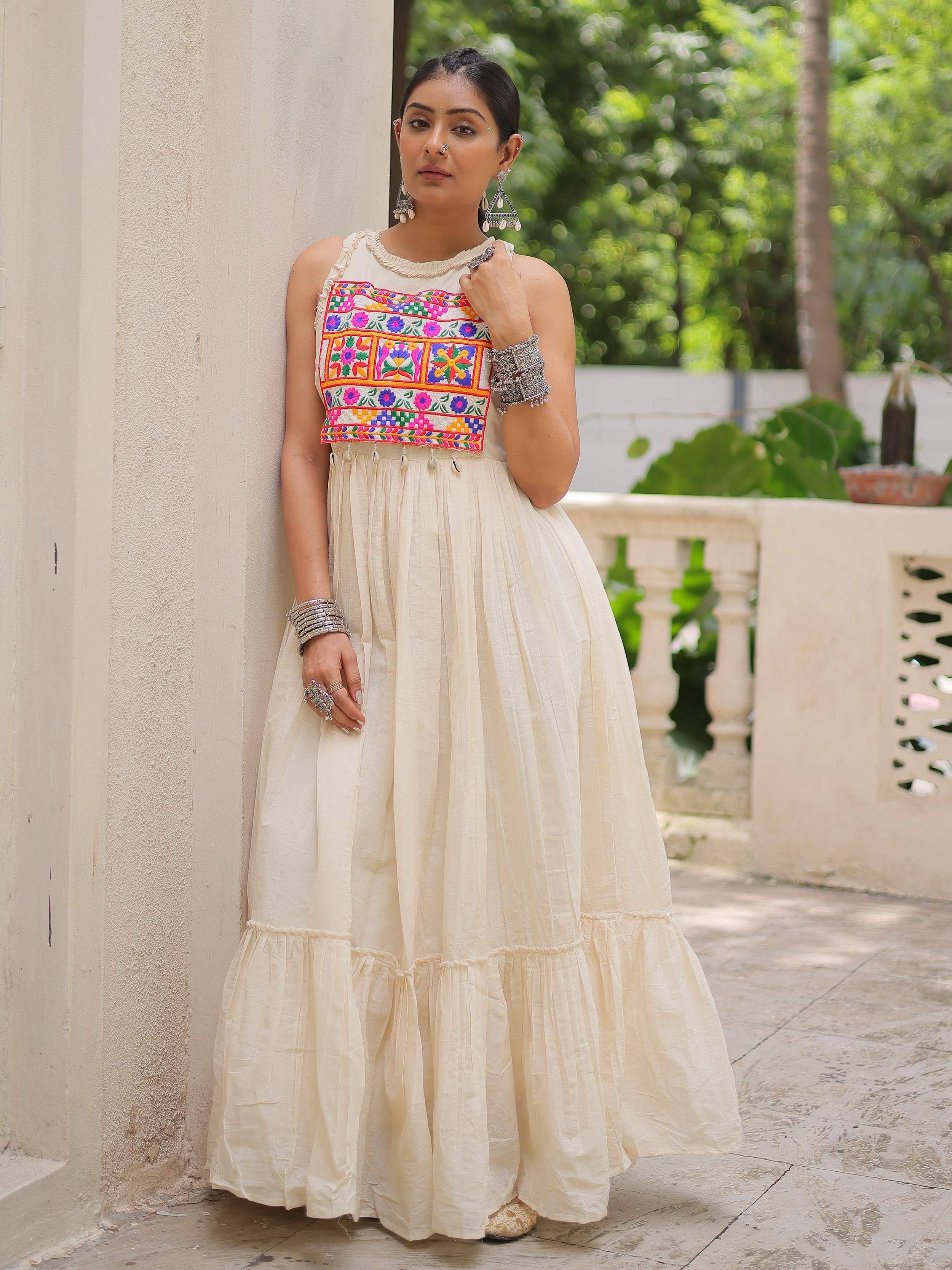 Cream ethnic gown with colorful floral embroidery, perfect for Indian occasions and festive wear.