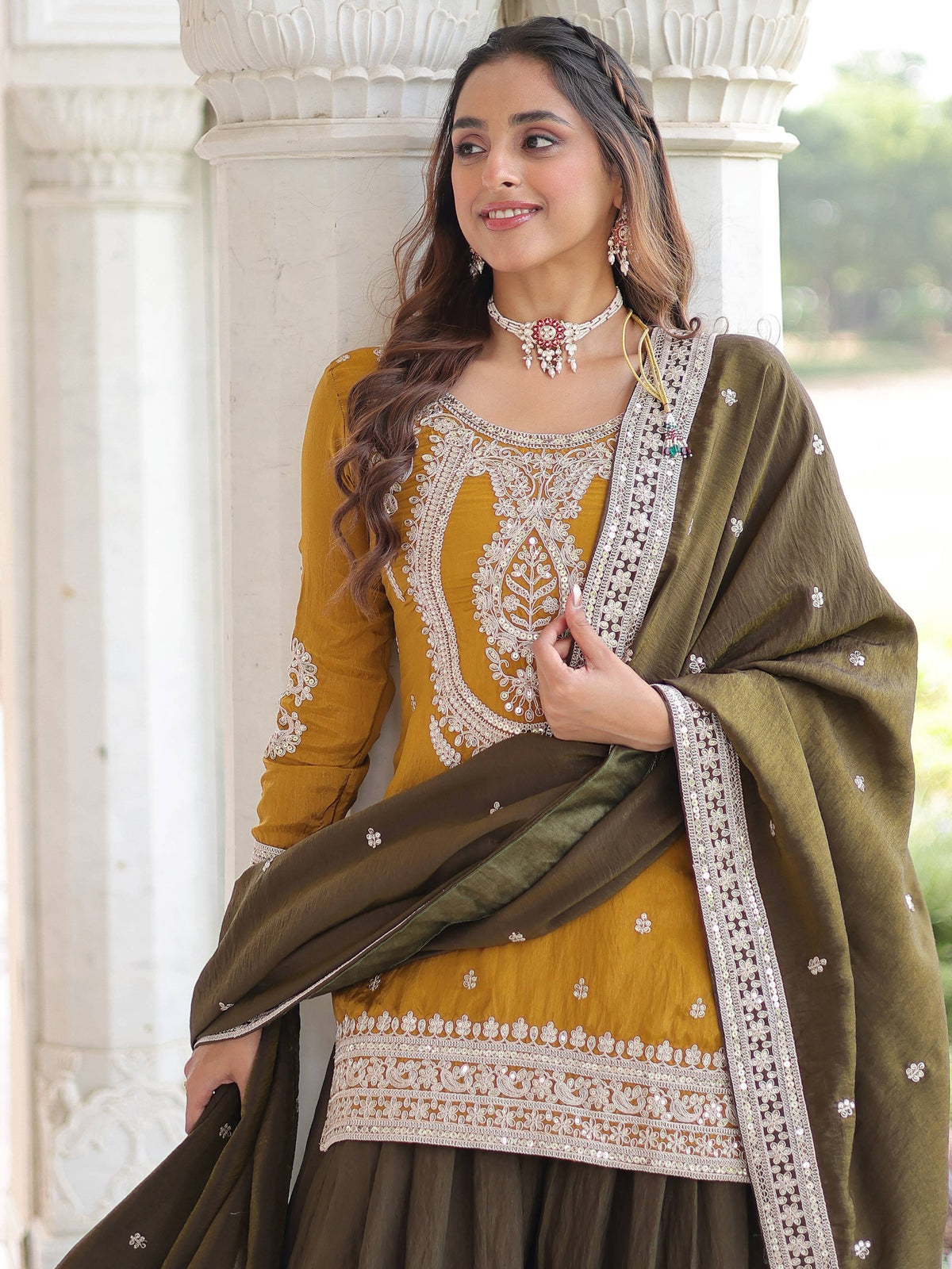 Mustard and olive green embroidered salwar kameez with detailed neckline and dupatta, perfect for ethnic occasions.