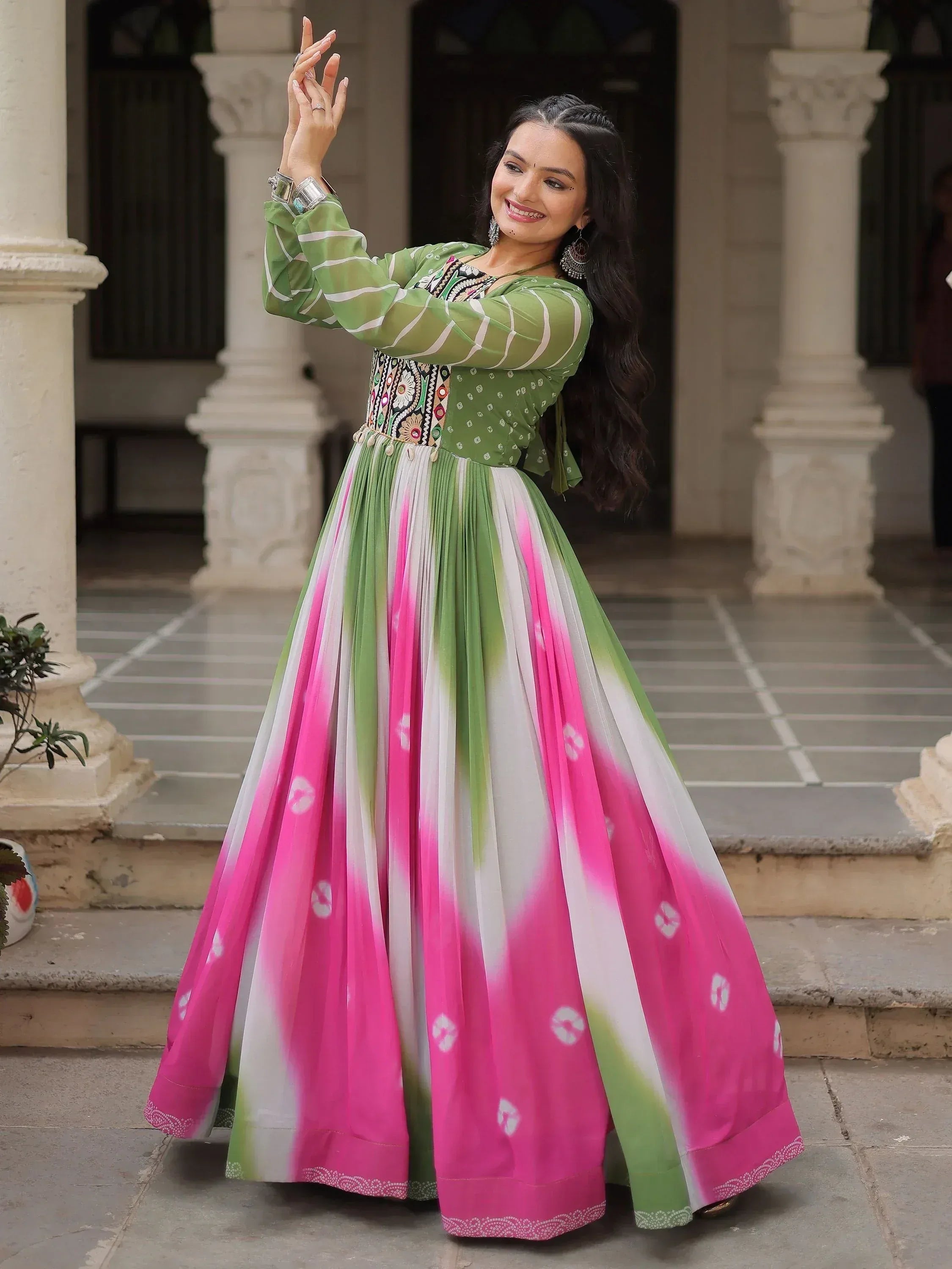 Woman in green and pink ethnic gown with embroidery, perfect for Indian festive occasions