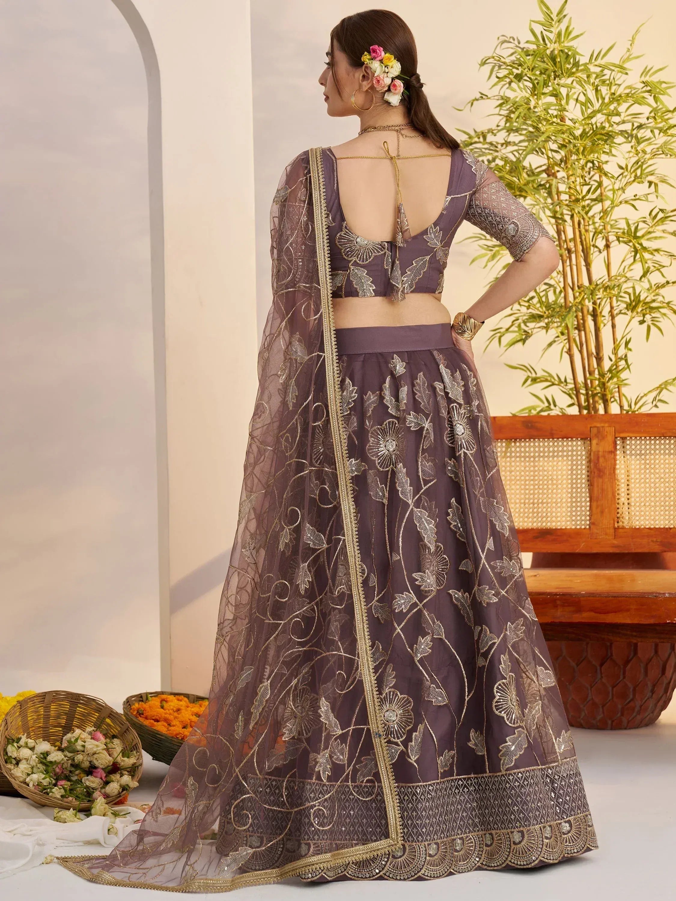 Elegant purple lehenga choli with gold floral embroidery and sheer dupatta, perfect for Indian ethnic wear.