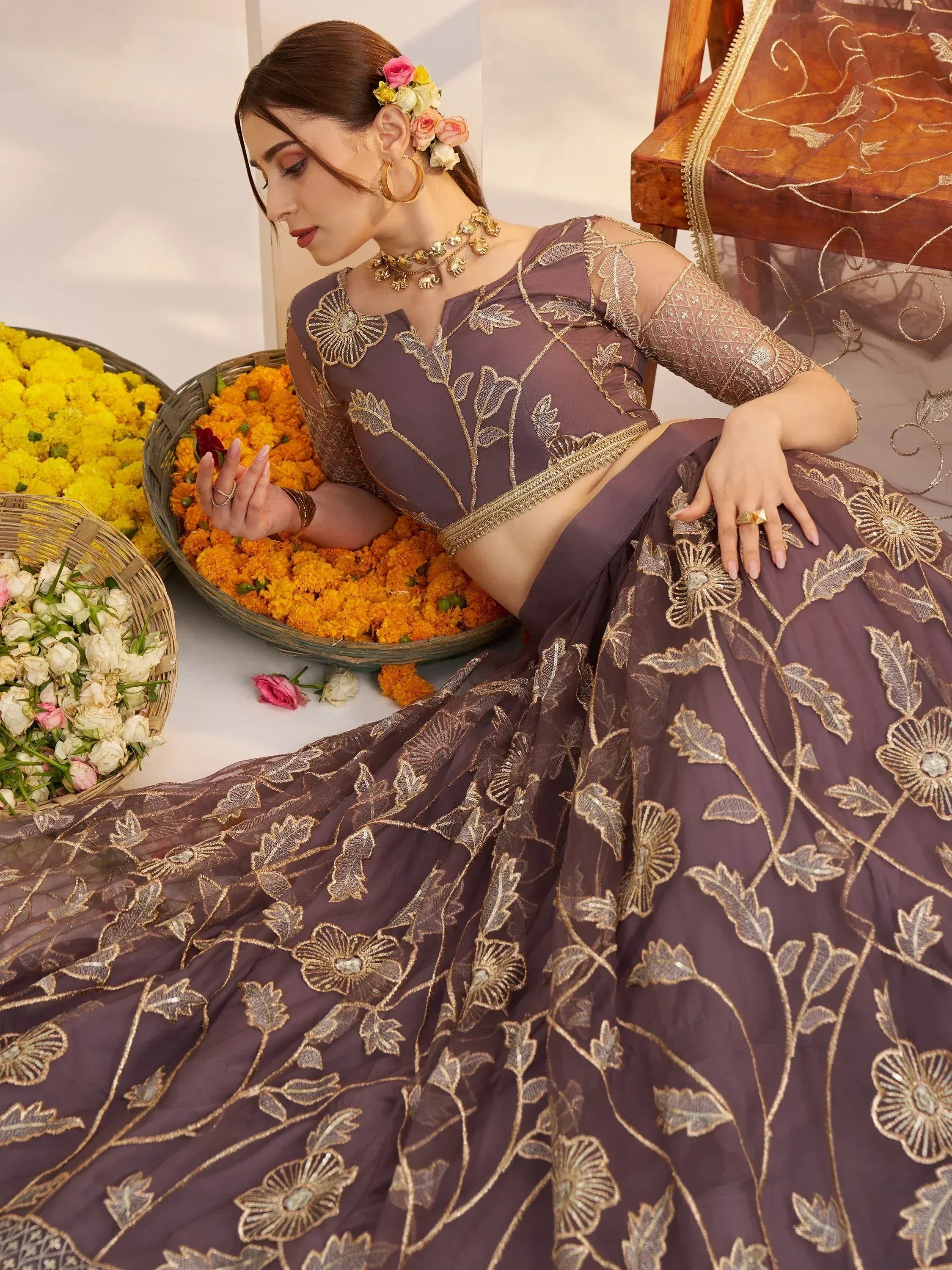 Elegant purple lehenga choli with gold floral embroidery, perfect for Indian ethnic wear occasions.