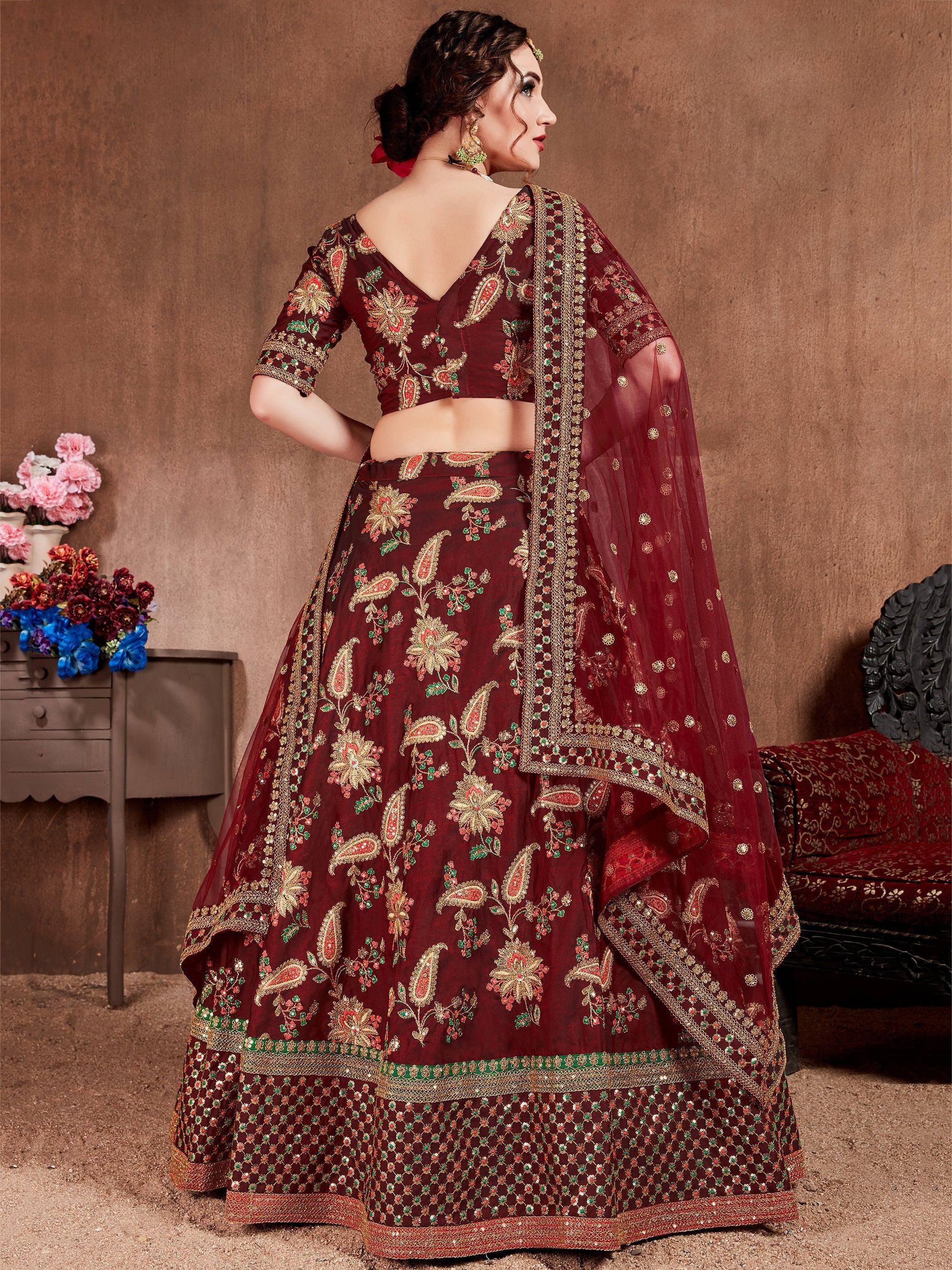Maroon embroidered lehenga choli with floral and paisley motifs, perfect for Indian weddings and festive occasions.