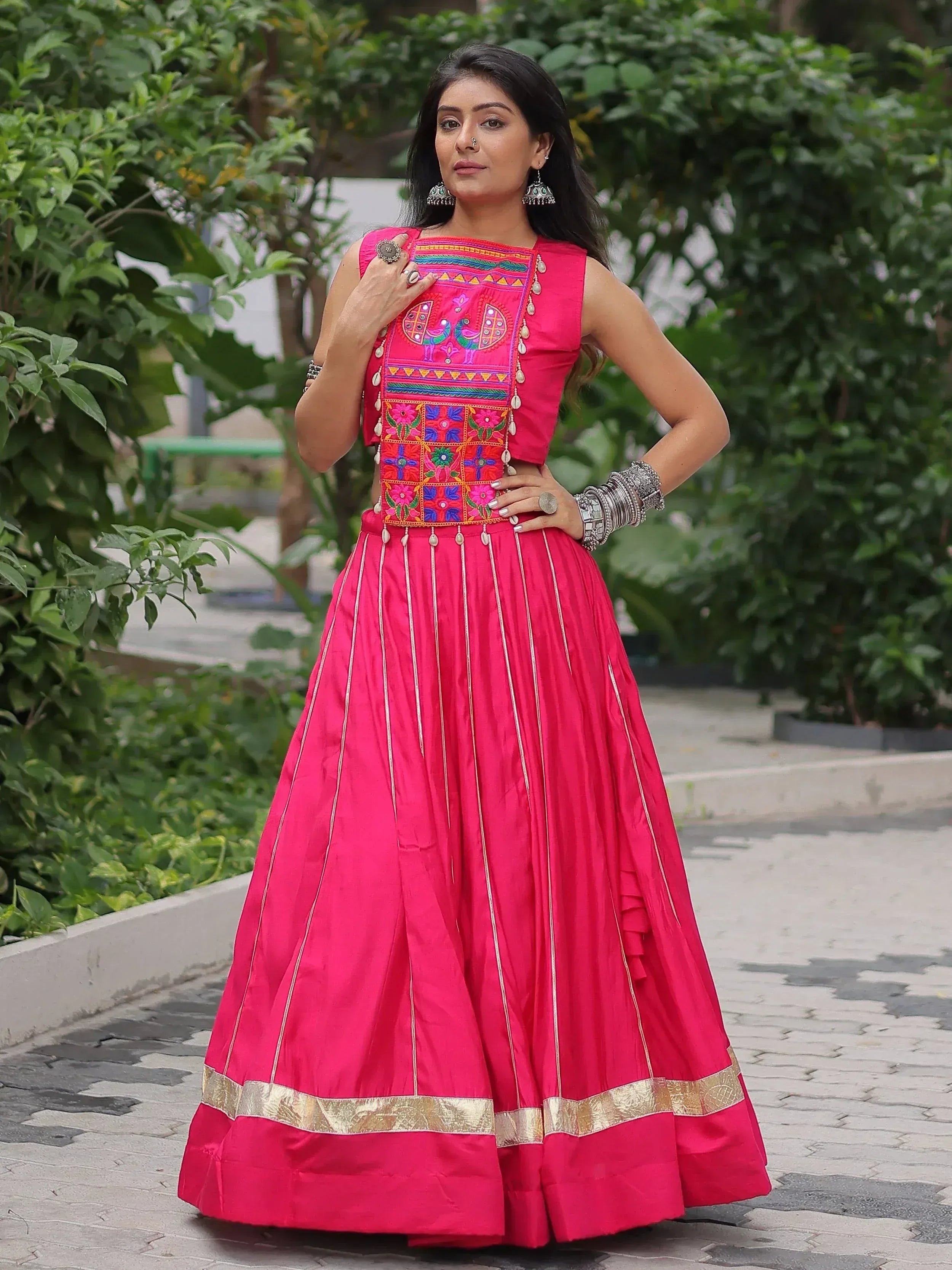 Pink embroidered lehenga choli with mirror work and gold border, perfect for Indian ethnic wear occasions