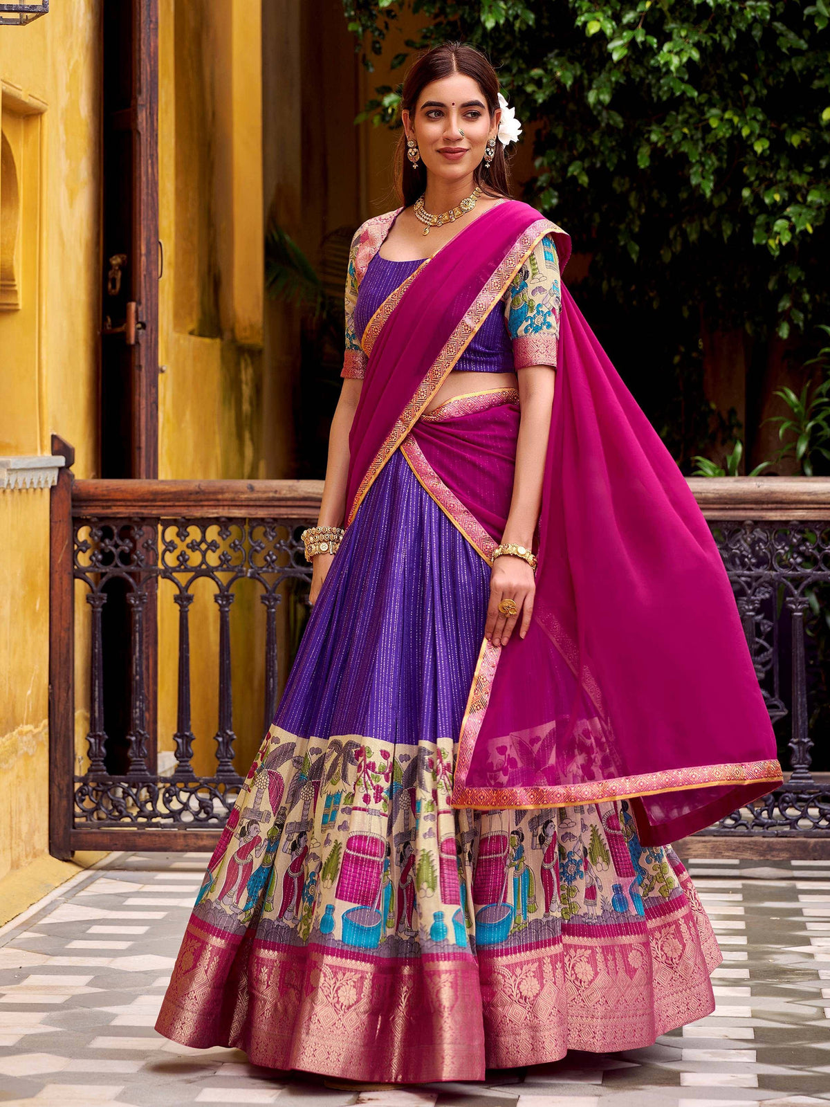 Purple and pink designer lehenga choli with intricate prints and gold embroidery