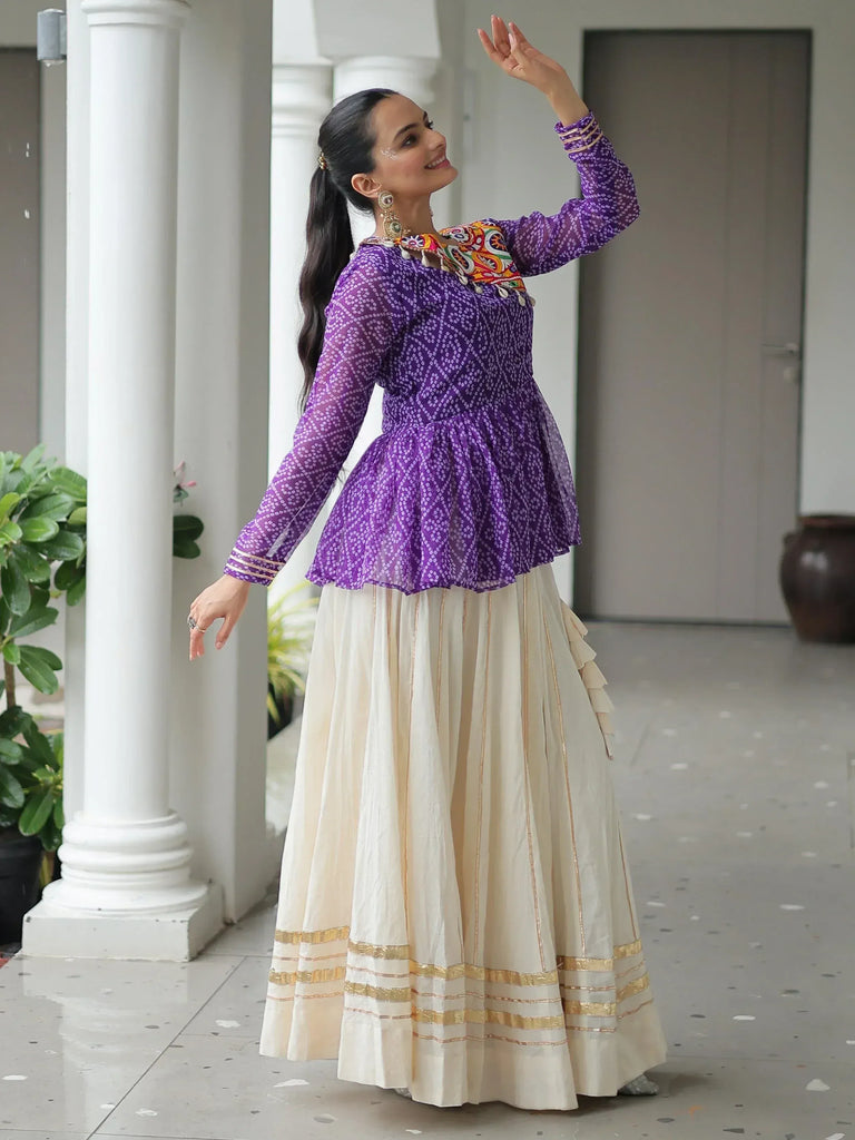 Woman in purple printed peplum top with cream pleated skirt, Indian ethnic wear
