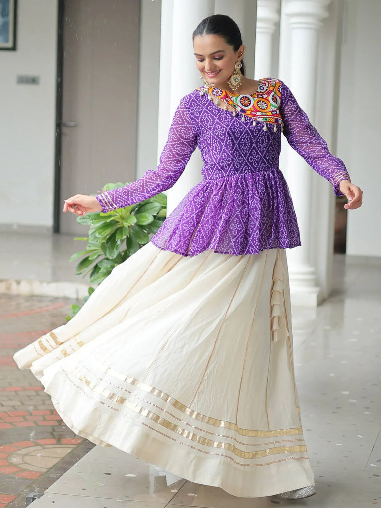 Woman in purple embroidered top and cream pleated skirt, Indian ethnic wear for festive occasions