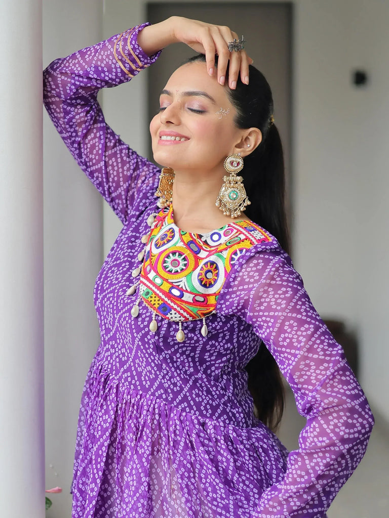 Purple ethnic kurti with colorful mirror work and sheer sleeves, paired with traditional jhumka earrings