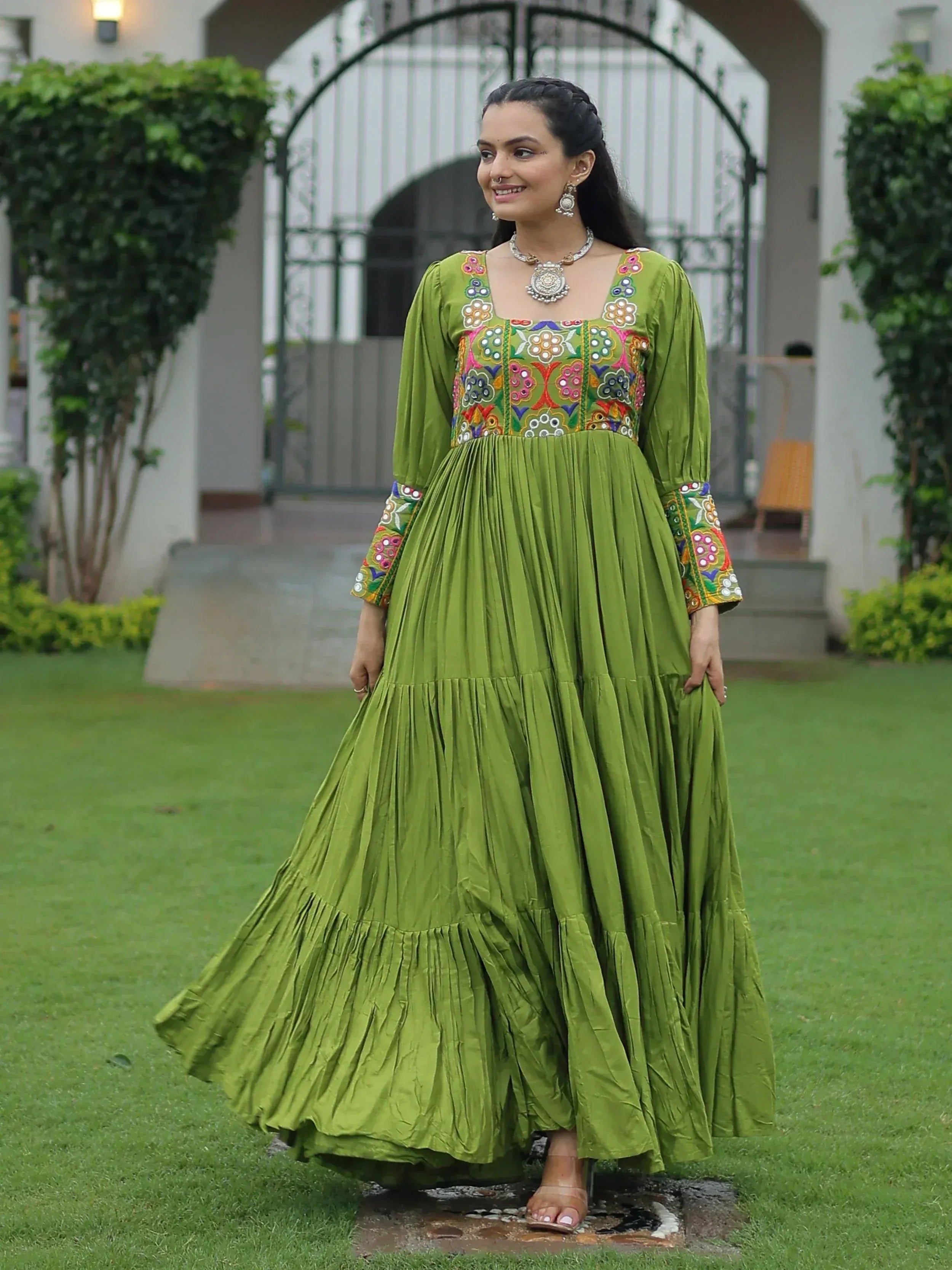 Green embroidered ethnic gown with floral motifs, pleated skirt, perfect for Indian festive wear