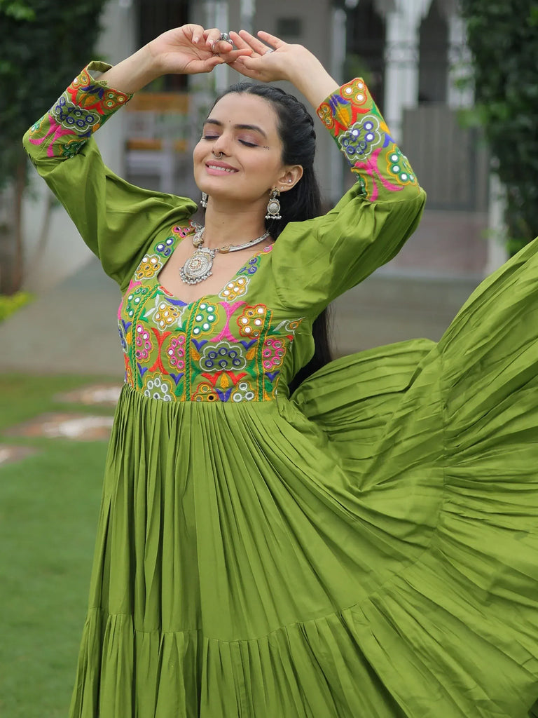 Green embroidered ethnic gown with mirror work, perfect for festive occasions and Indian celebrations.