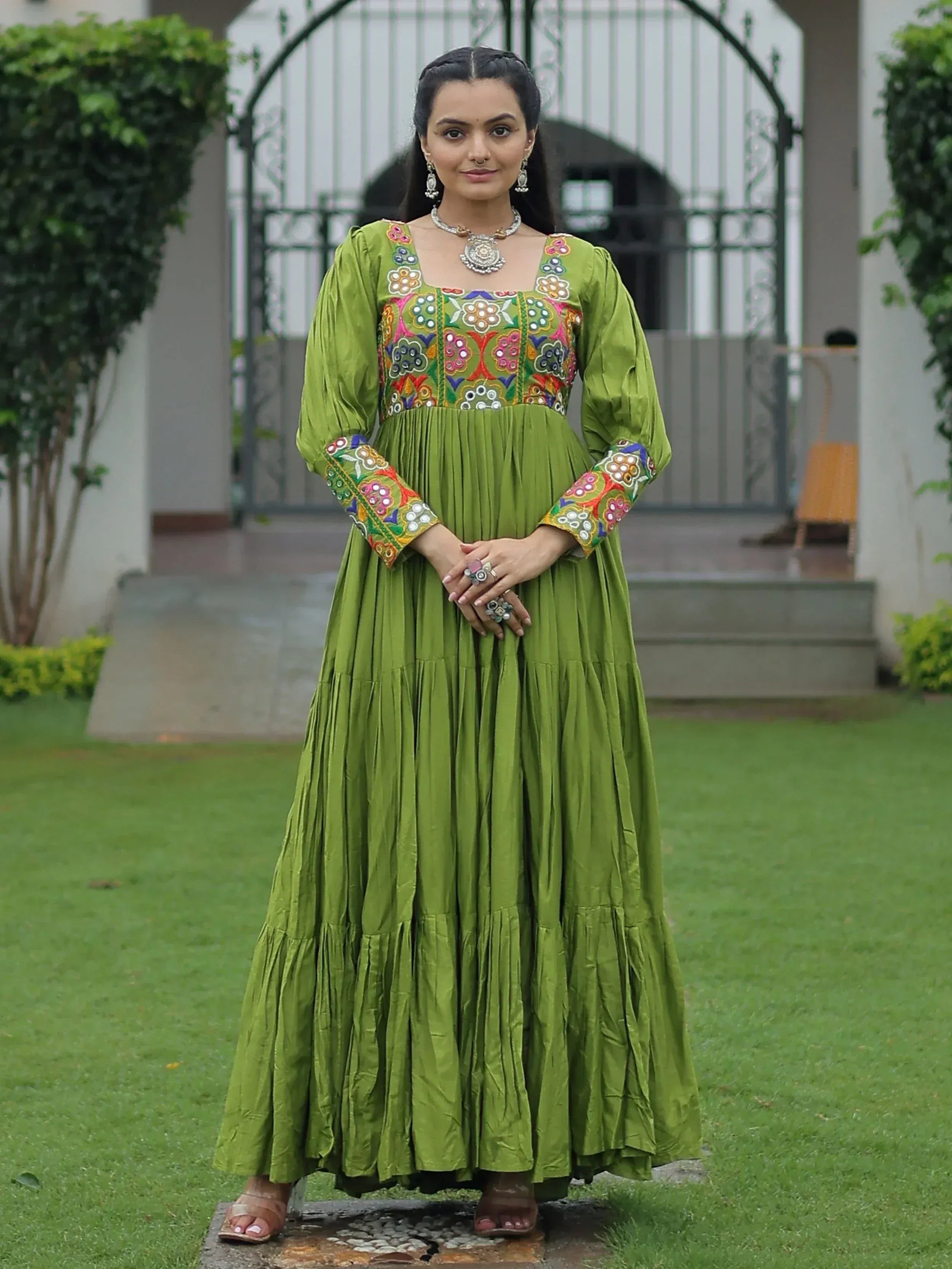 Green embroidered ethnic gown with floral mirror work, perfect for Indian festive occasions