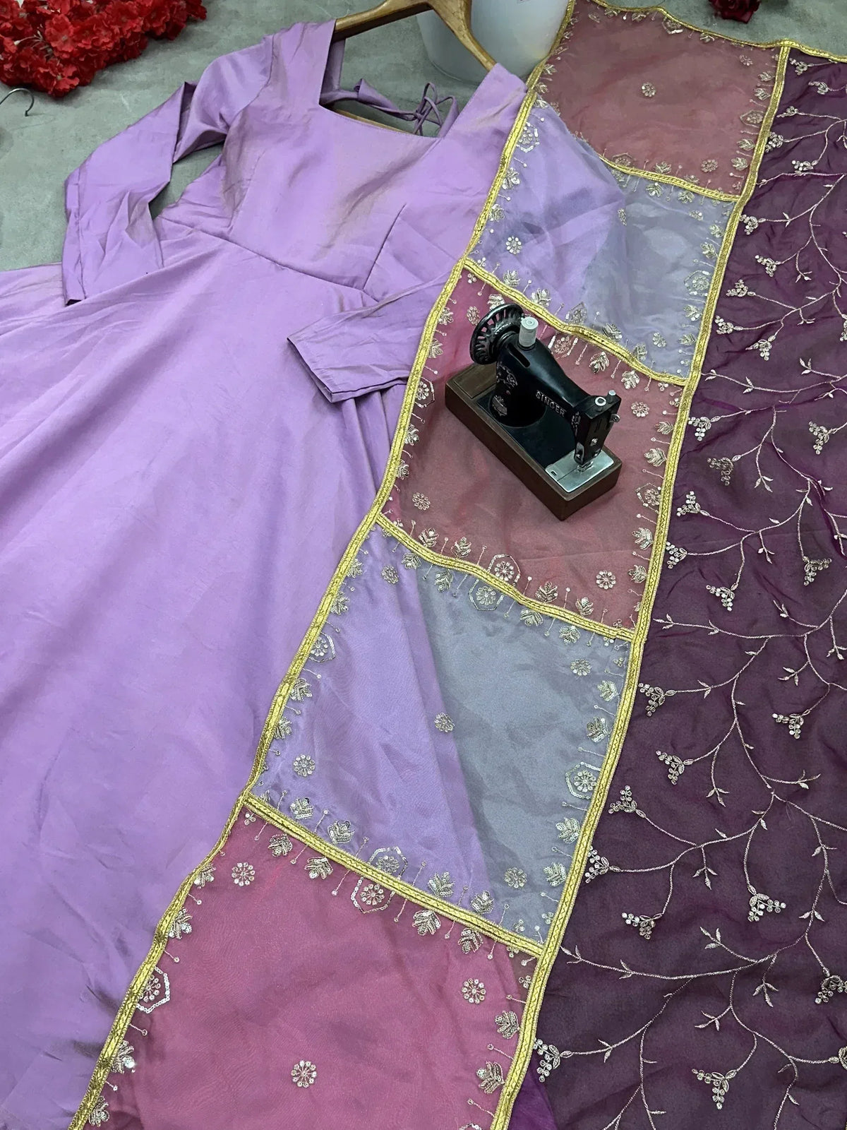 Purple designer ethnic gown with embroidered dupatta and vintage sewing machine