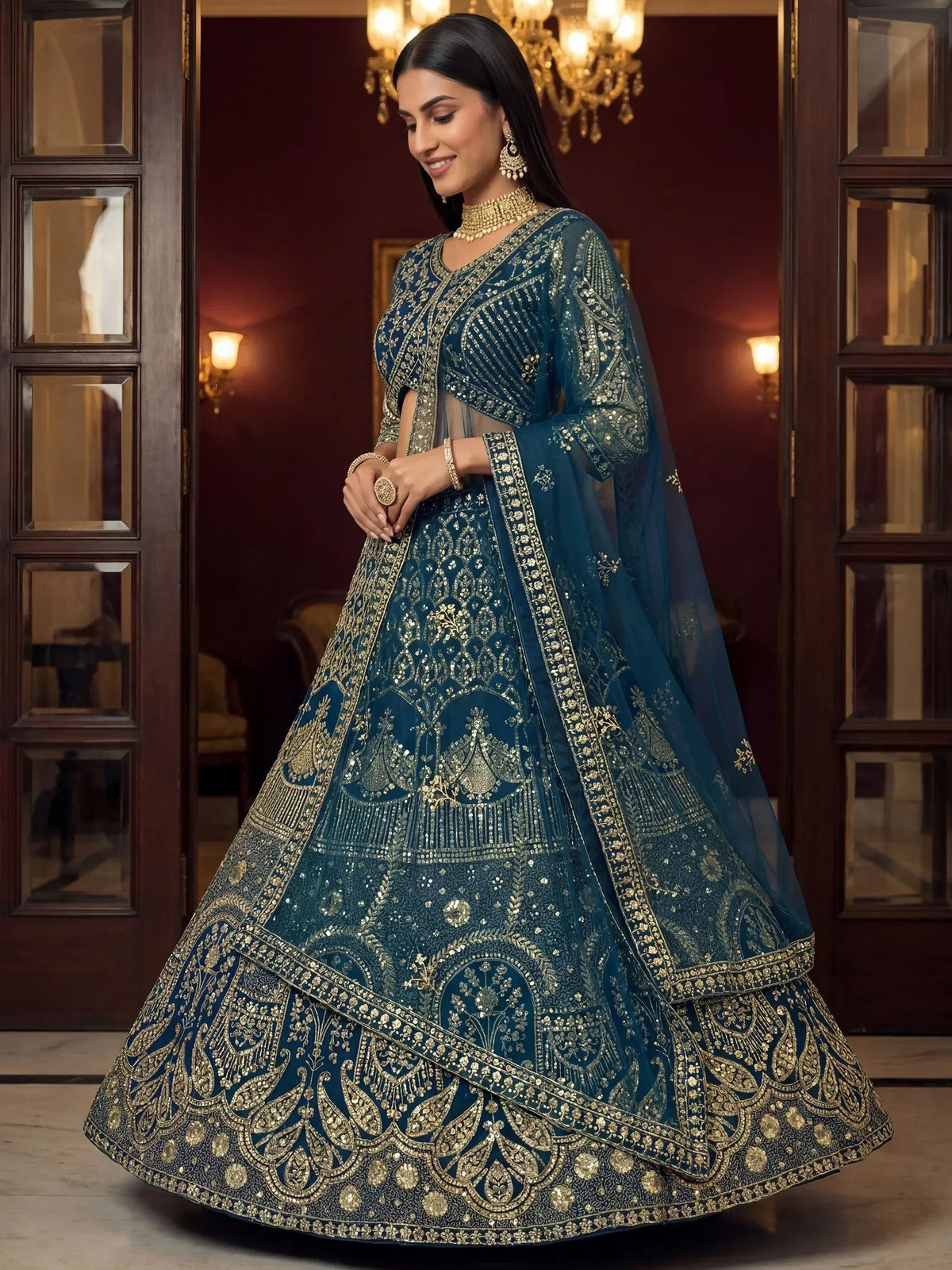 Teal blue designer lehenga choli with gold embroidery, perfect for Indian weddings and festive occasions.