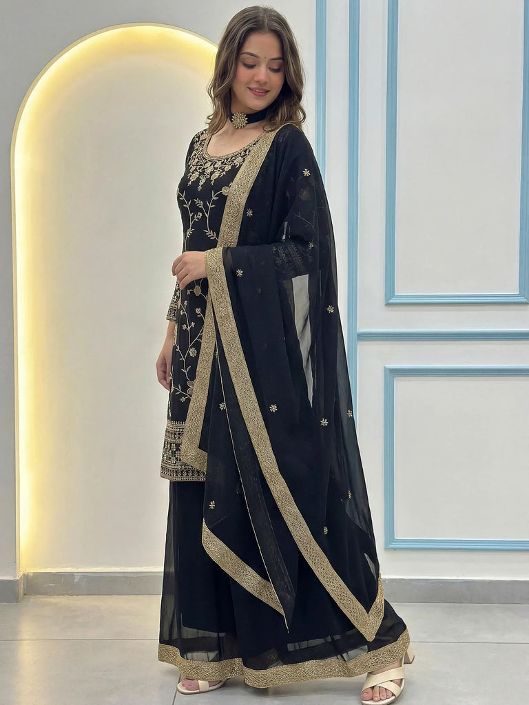 Black embroidered salwar kameez with gold detailing, perfect for ethnic wear and festive occasions.