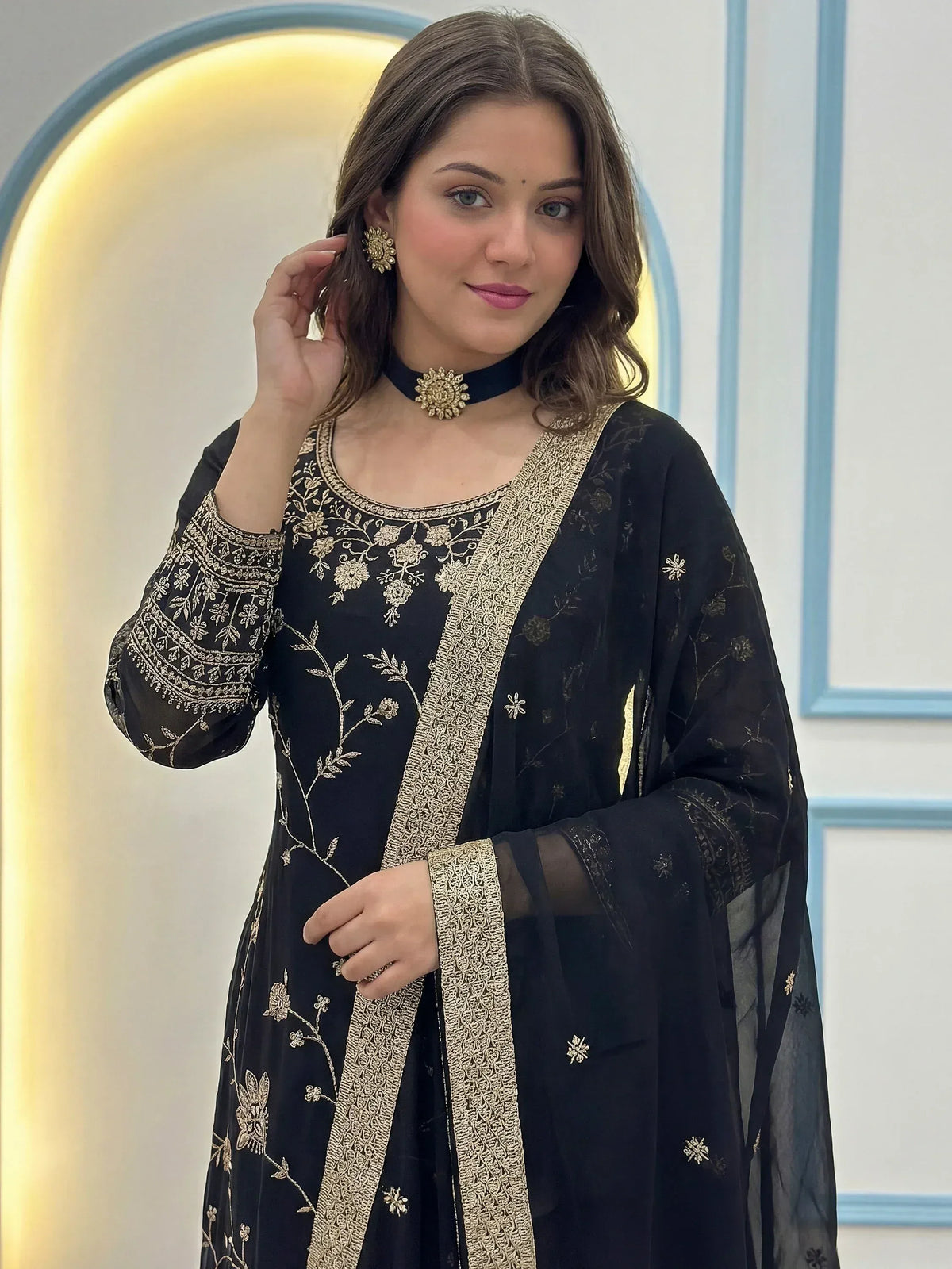 Black embroidered ethnic gown with gold floral detailing, perfect for Indian occasions and festive wear.