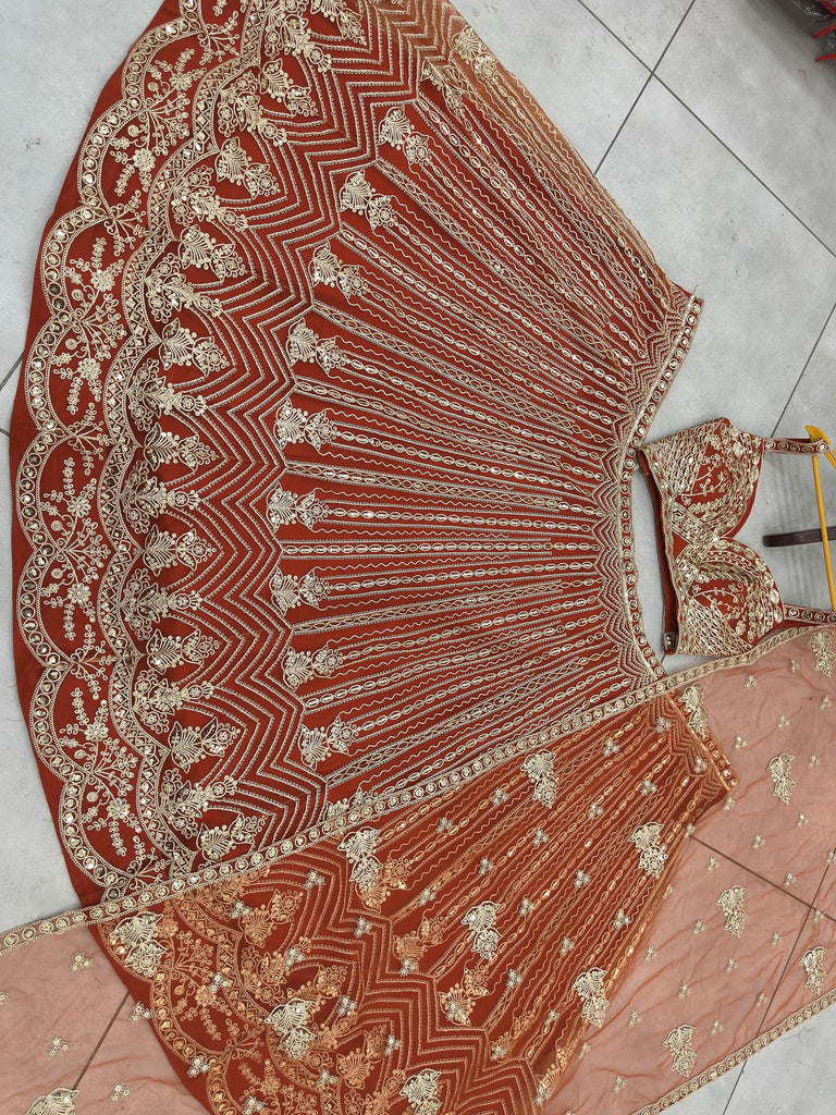 Grand Orange Heavy Embroidered Net Reception Wear Lehenga Choli