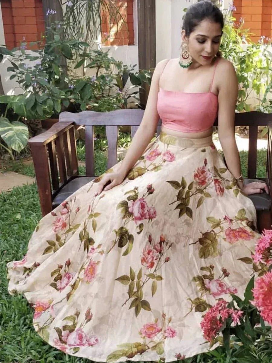 Woman in pink floral lehenga choli, ethnic Indian wear, garden setting
