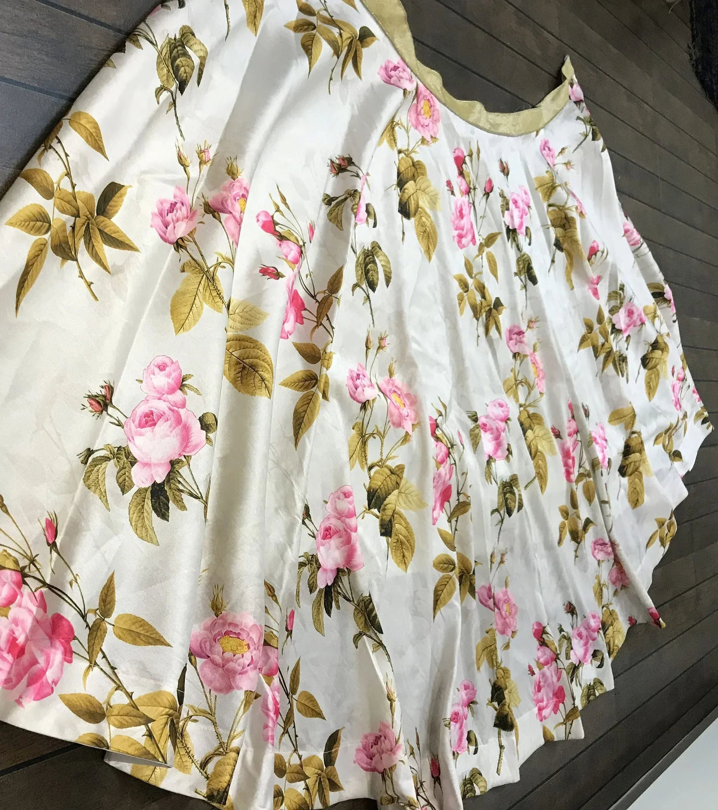 White floral ethnic gown with pink roses and gold leaves, perfect for Indian occasions