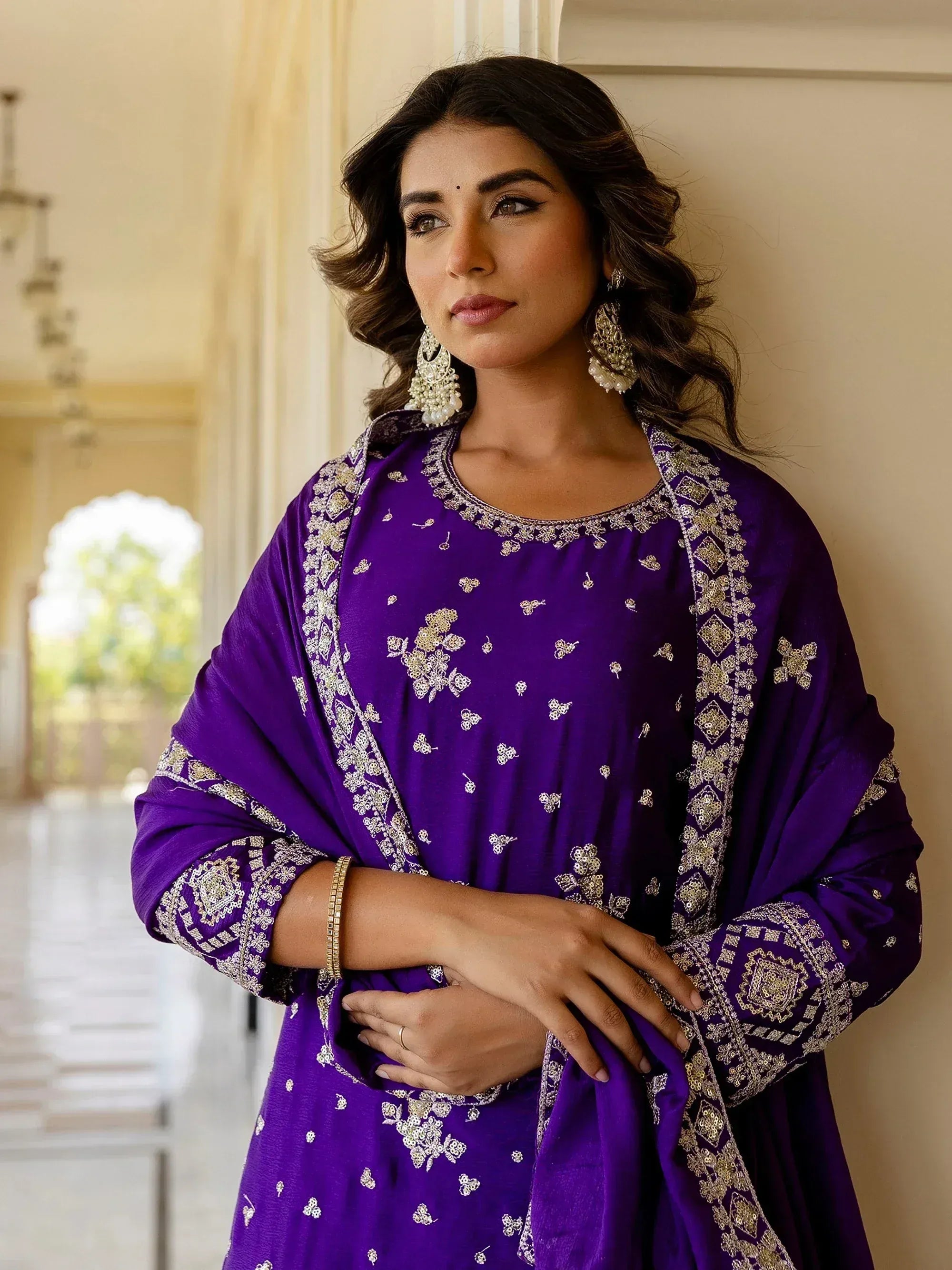 Purple embroidered ethnic gown with gold detailing, perfect for Indian festive occasions
