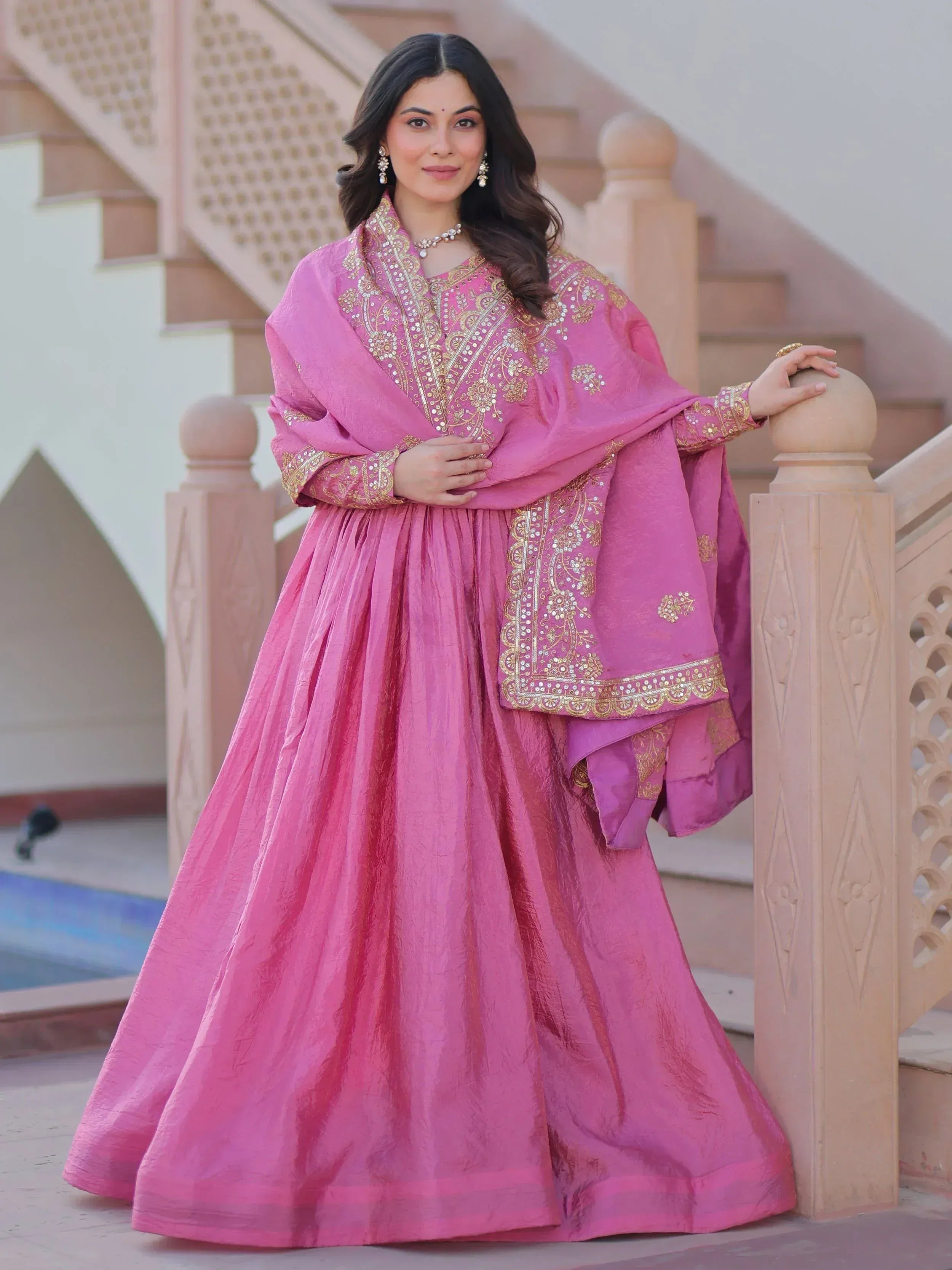 Pink embroidered Indian ethnic wear with gold detailing, perfect for festive occasions and weddings.