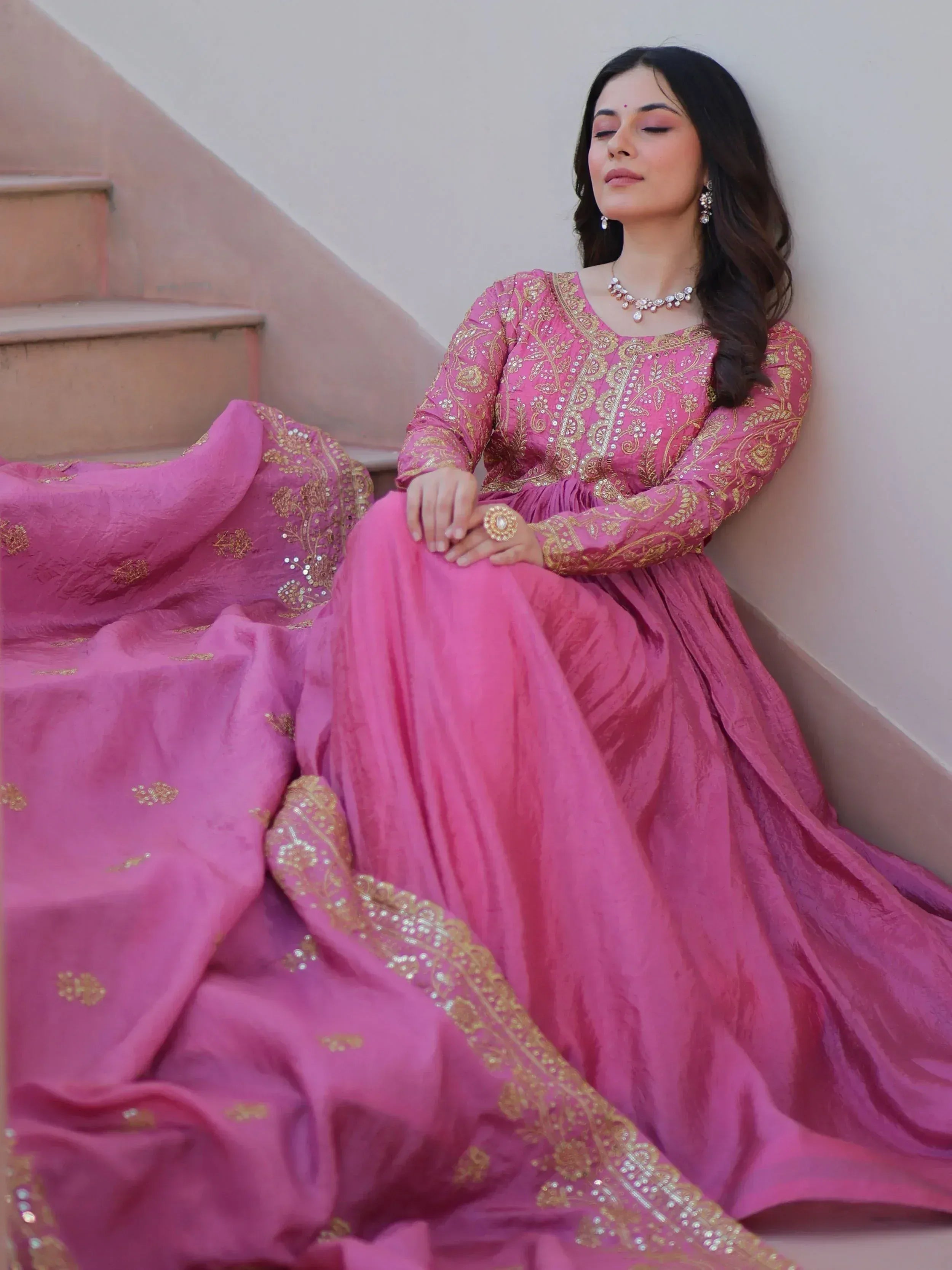 Pink embroidered ethnic gown with gold detailing, perfect for Indian weddings and festive occasions