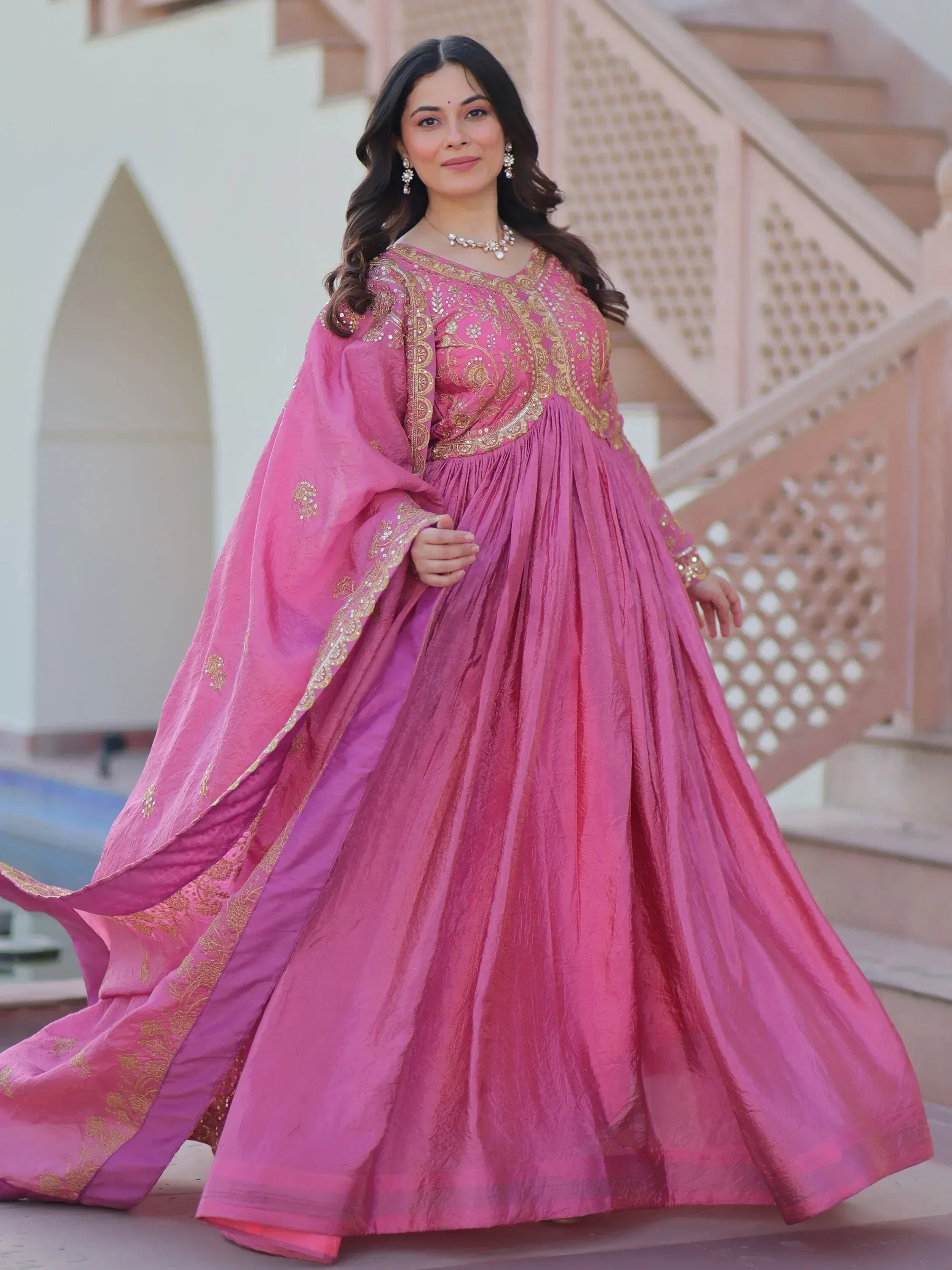 Pink ethnic gown with gold embroidery, perfect for Indian weddings and festive occasions