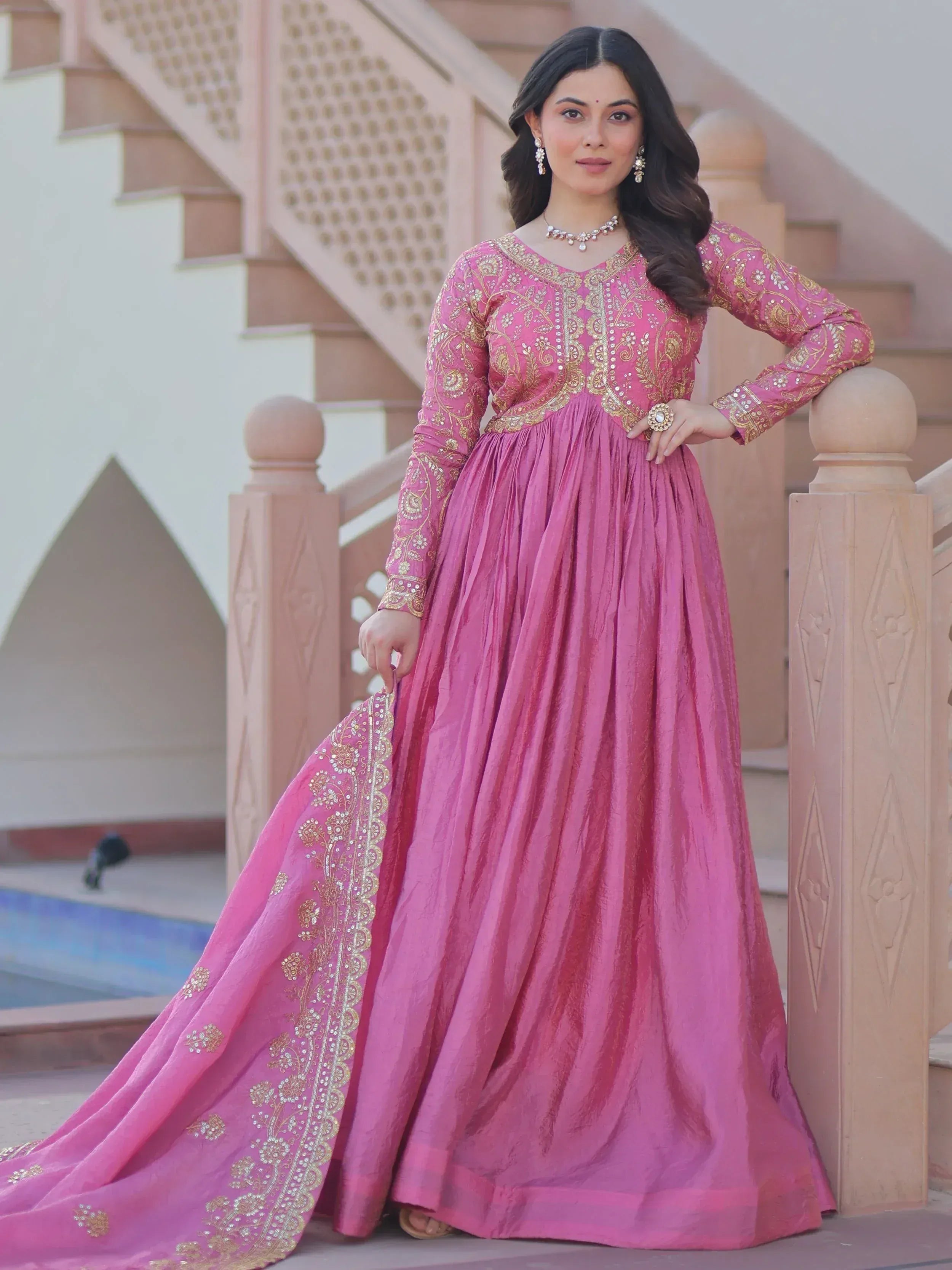 Pink ethnic gown with gold embroidery, perfect for Indian weddings and festive occasions